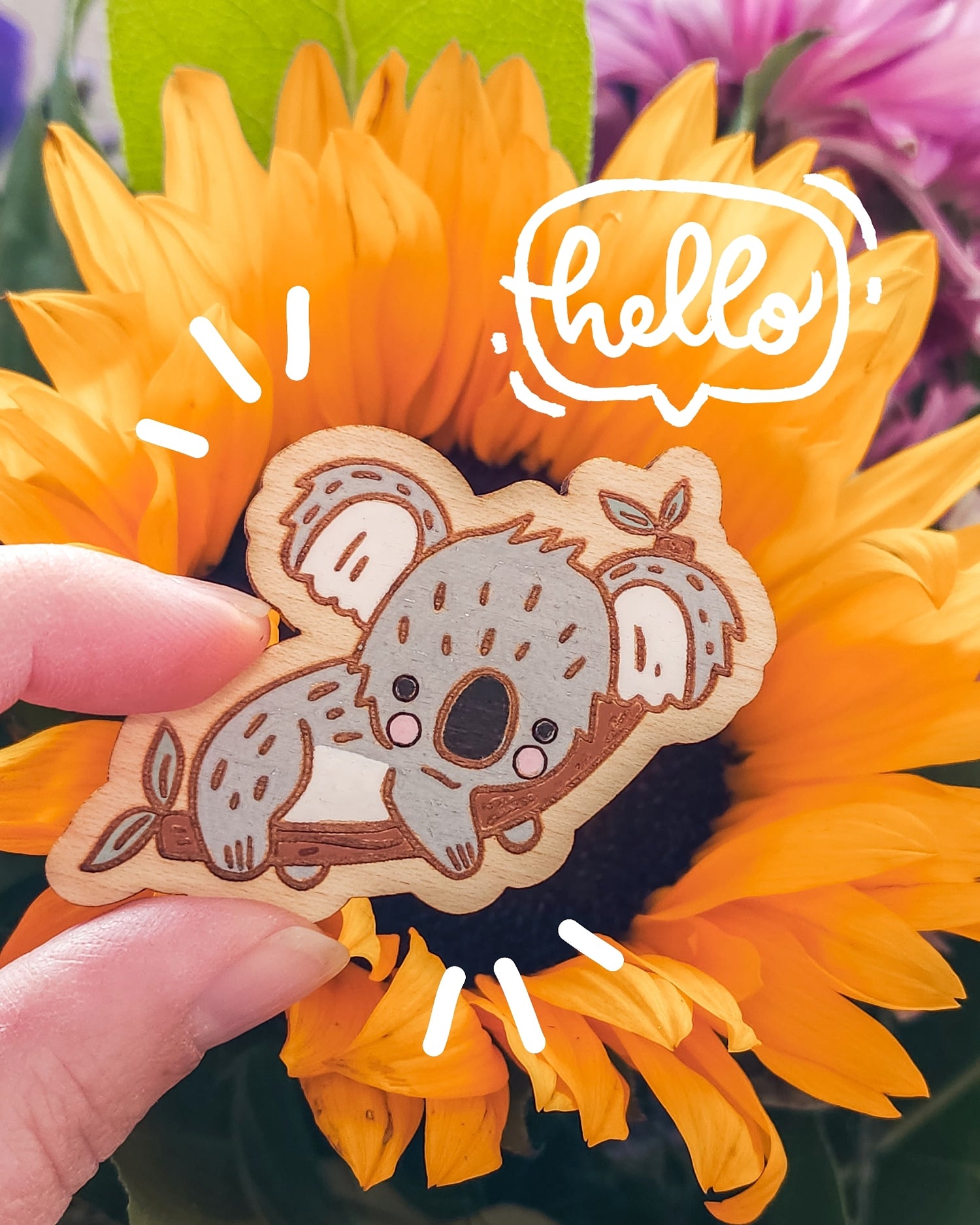 koala magnet in front of a sunflower with the word hello