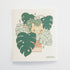 dishcloth with an image of a yellow cat hiding in a monstera plant