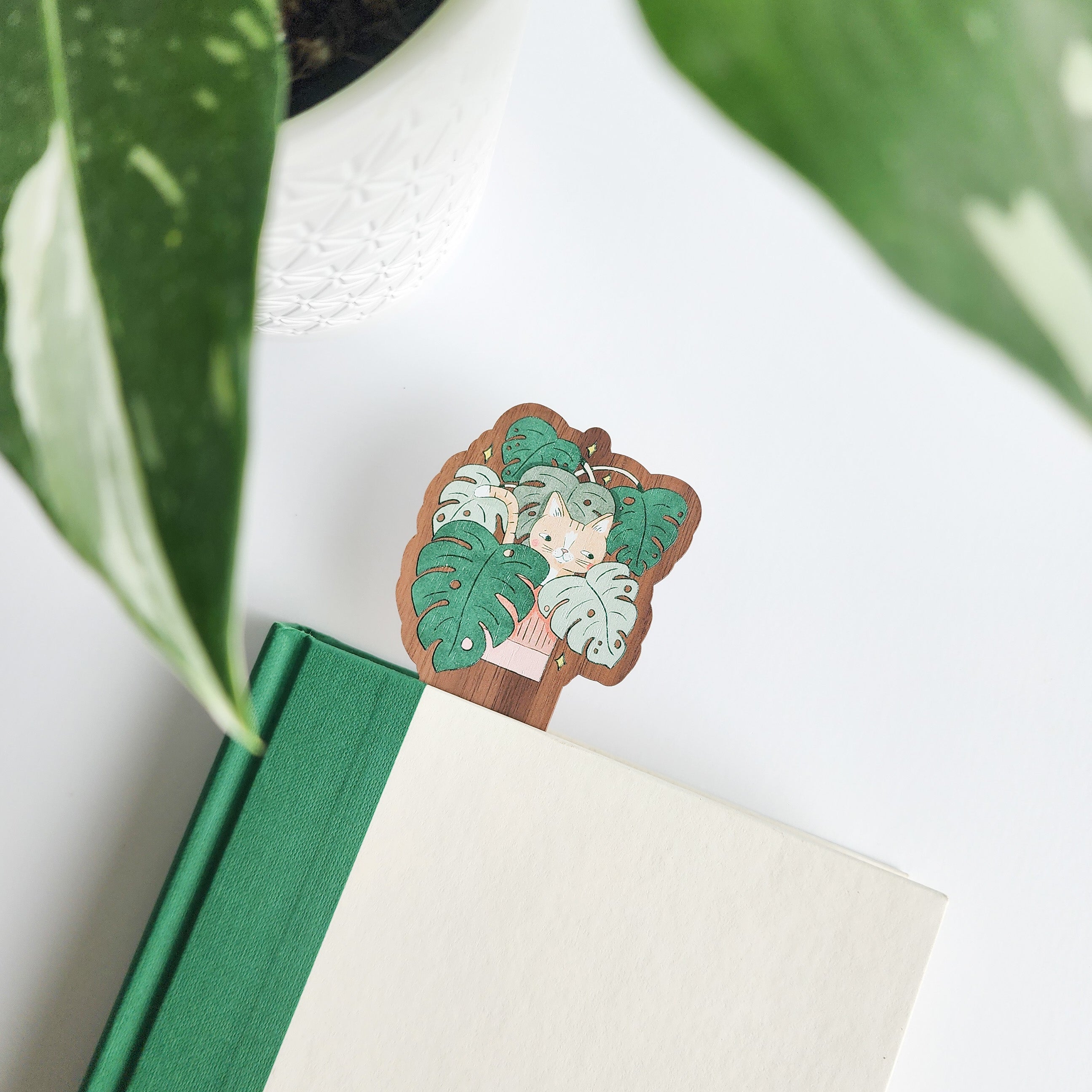 cat bookmark in a book on a white background