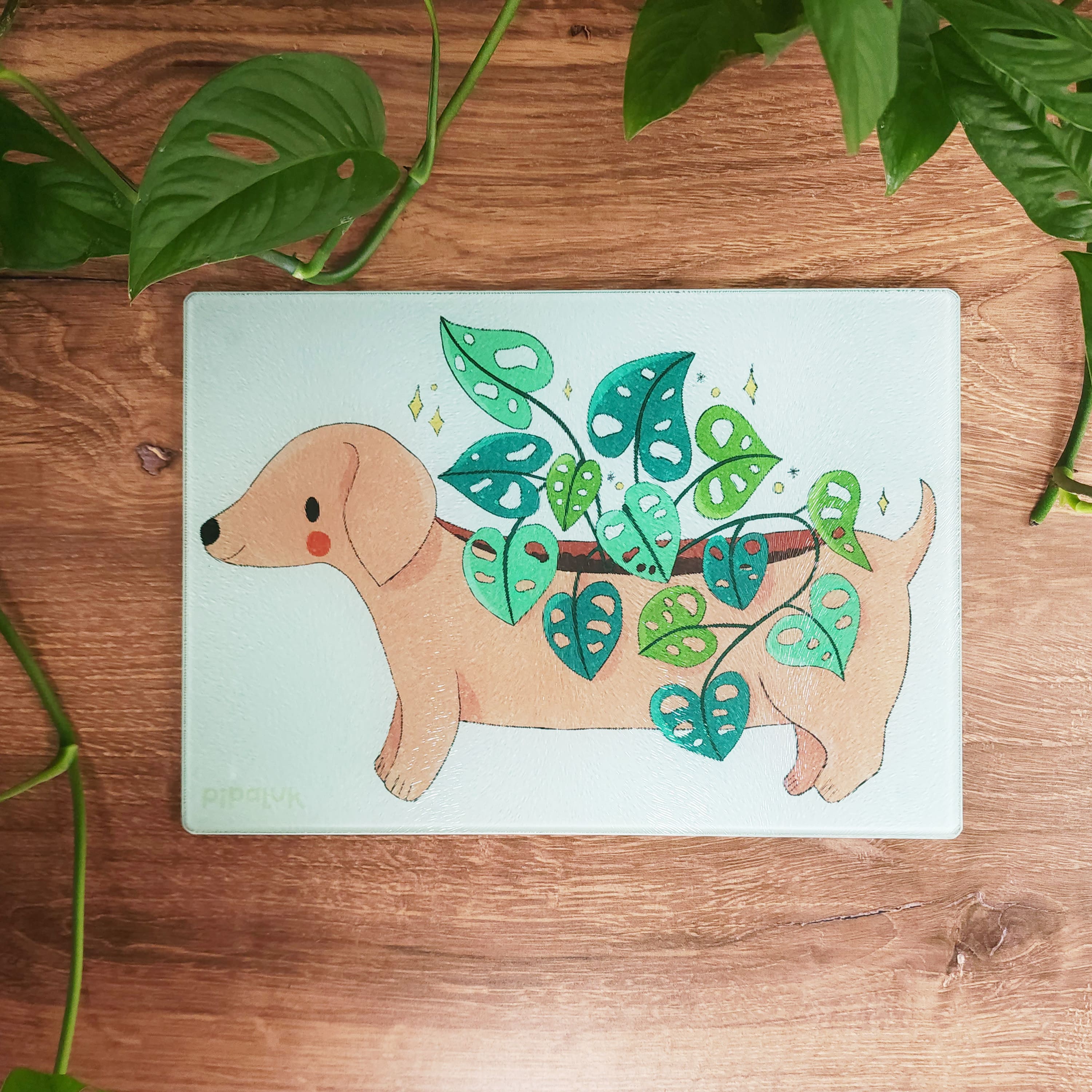 glass dachshund cutting board sitting on a wooden table