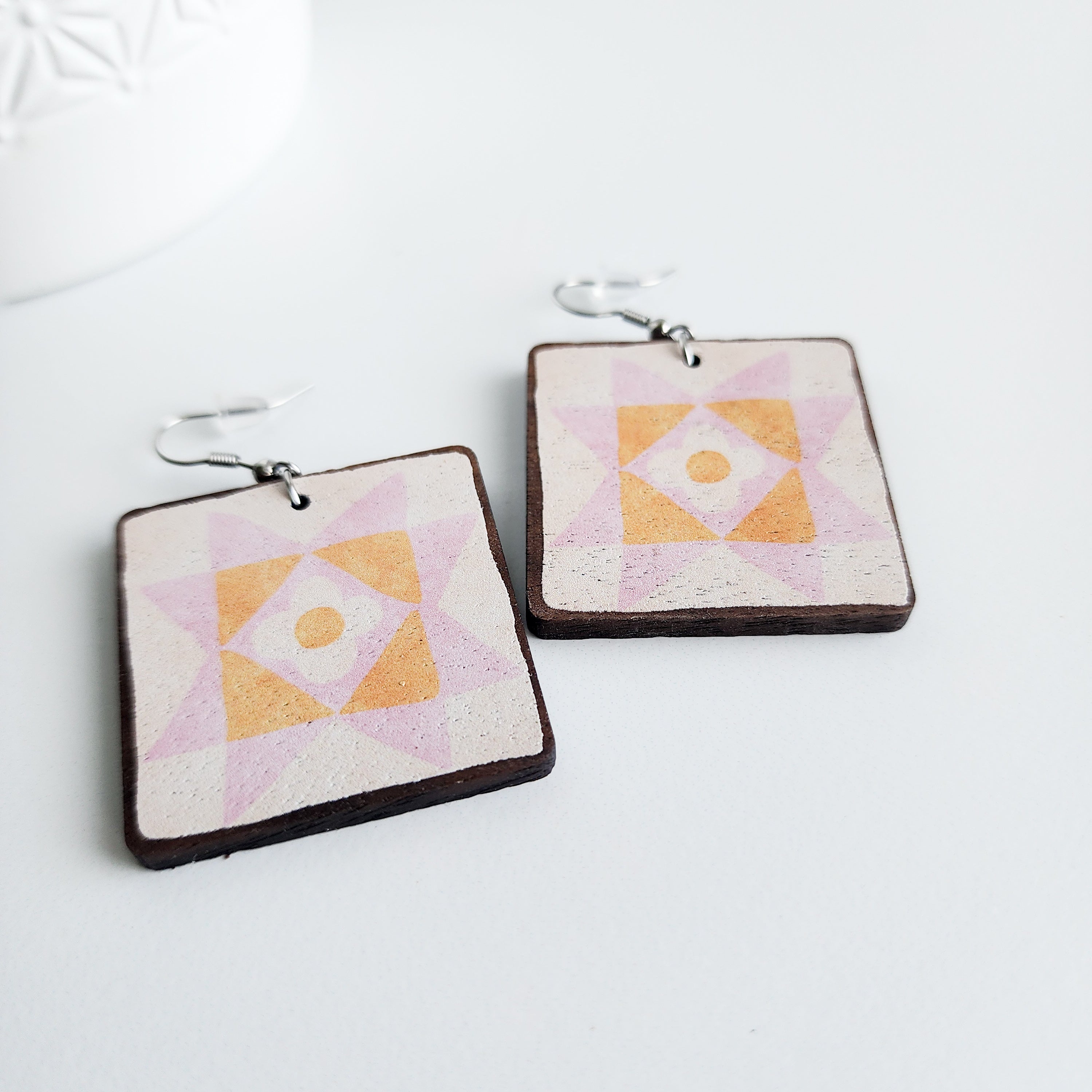 daisy star earrings close up on a white background