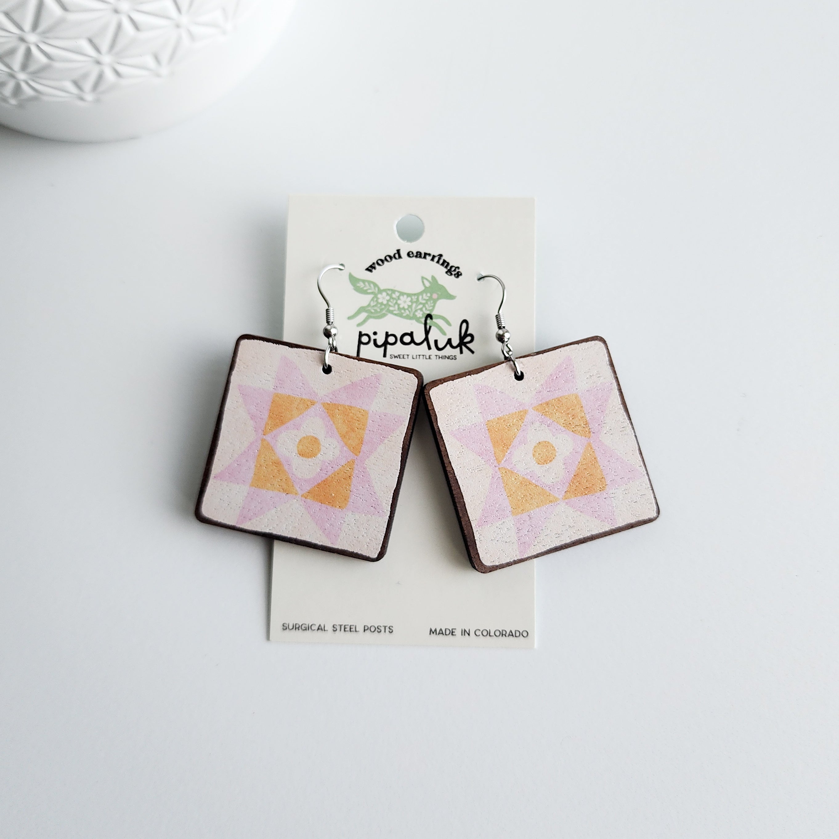 daisy star earrings on a pipaluk earring card on a white background