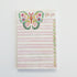 notepad with a colorful butterfly design on the cover, featuring the text &
