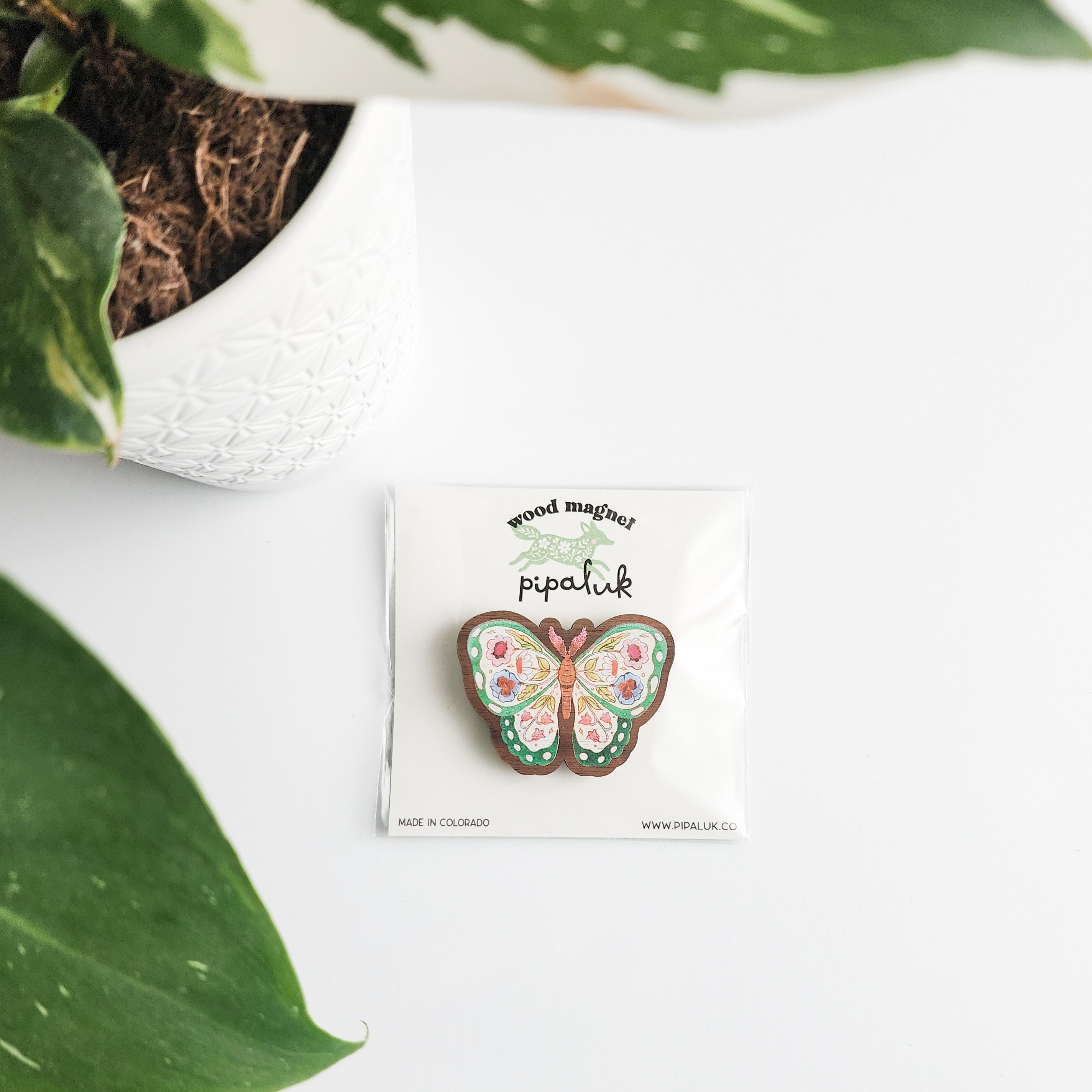 Butterfly-shaped wooden magnet on a card with &