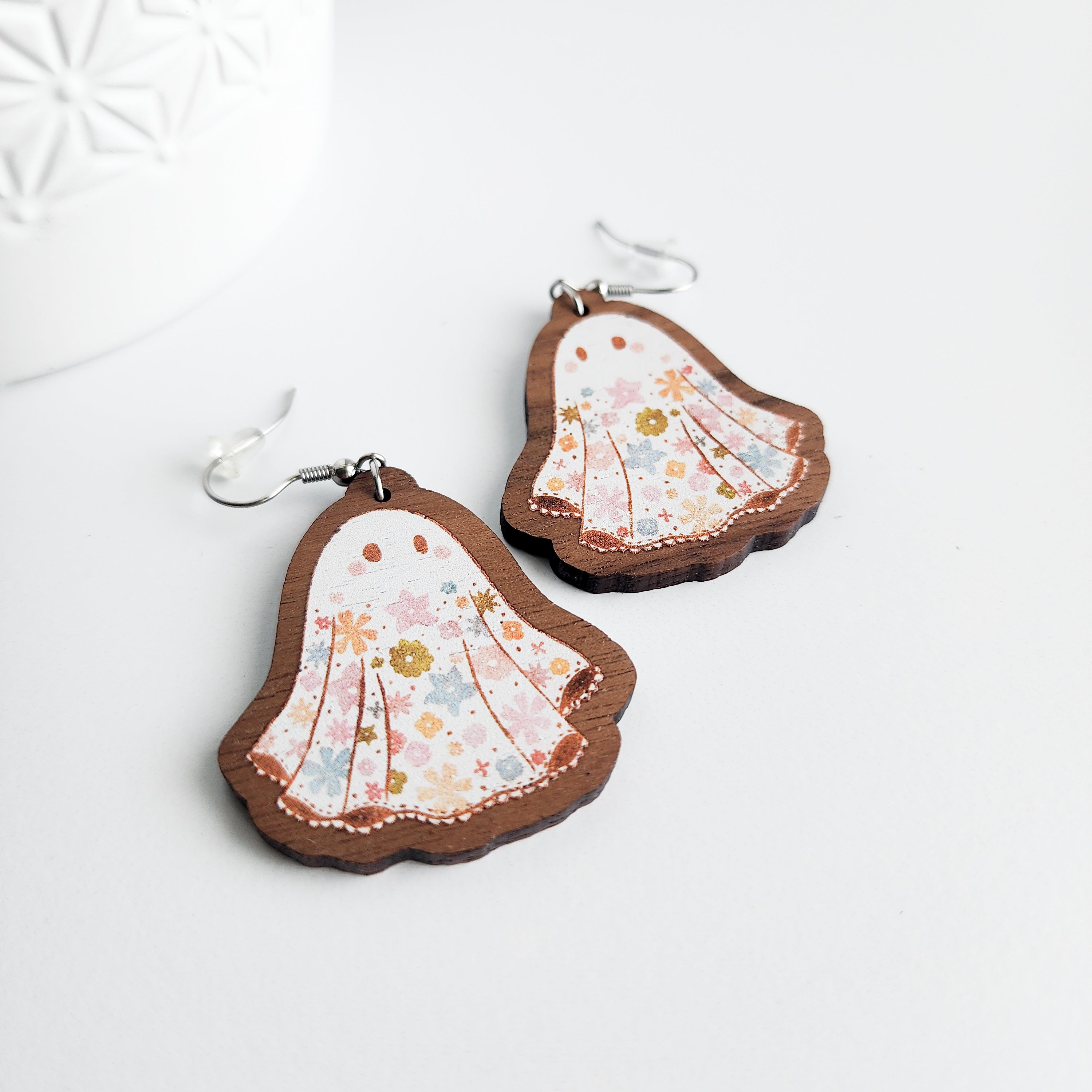 floral ghost earrings on a white background