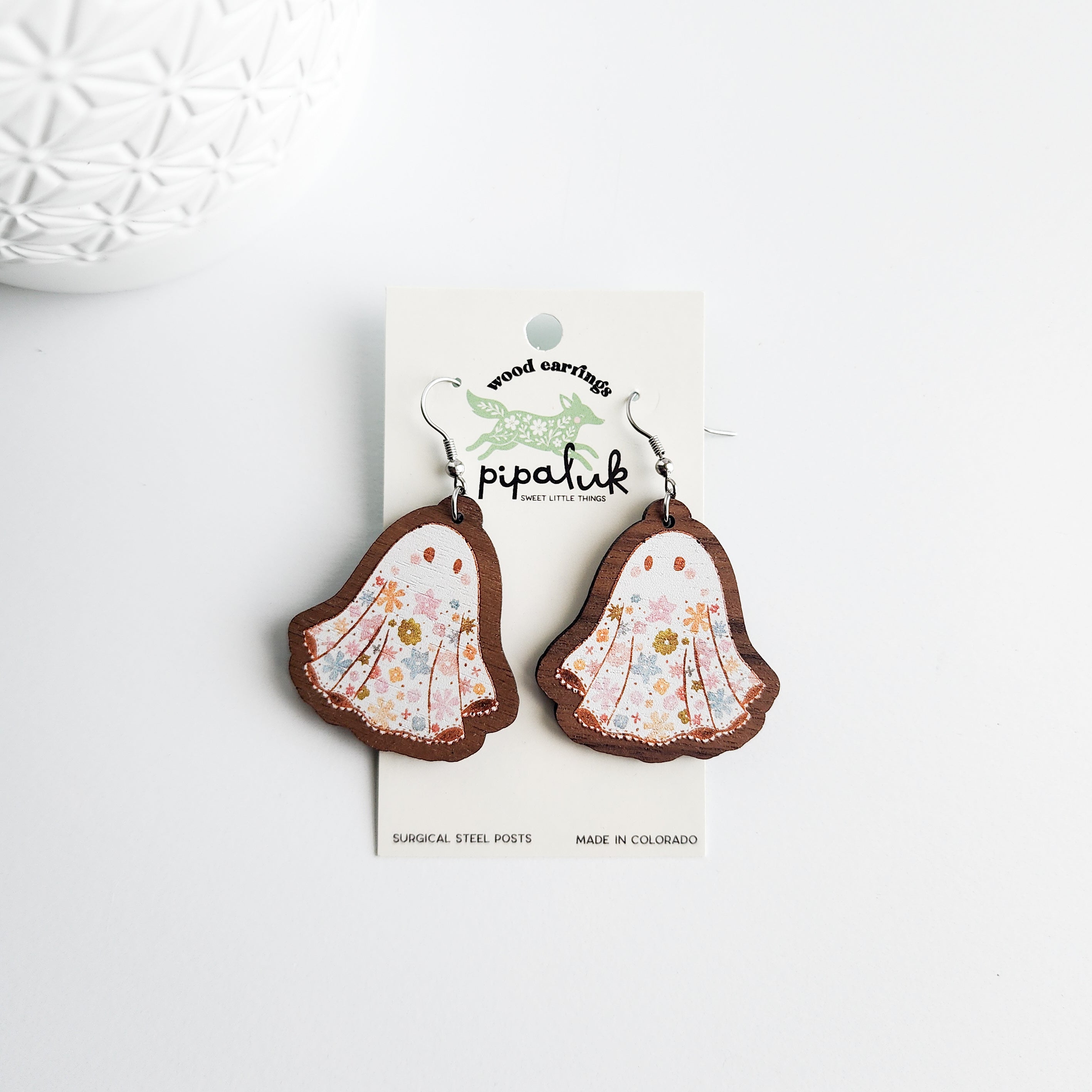 floral ghost earrings on a Pipaluk card on a white background
