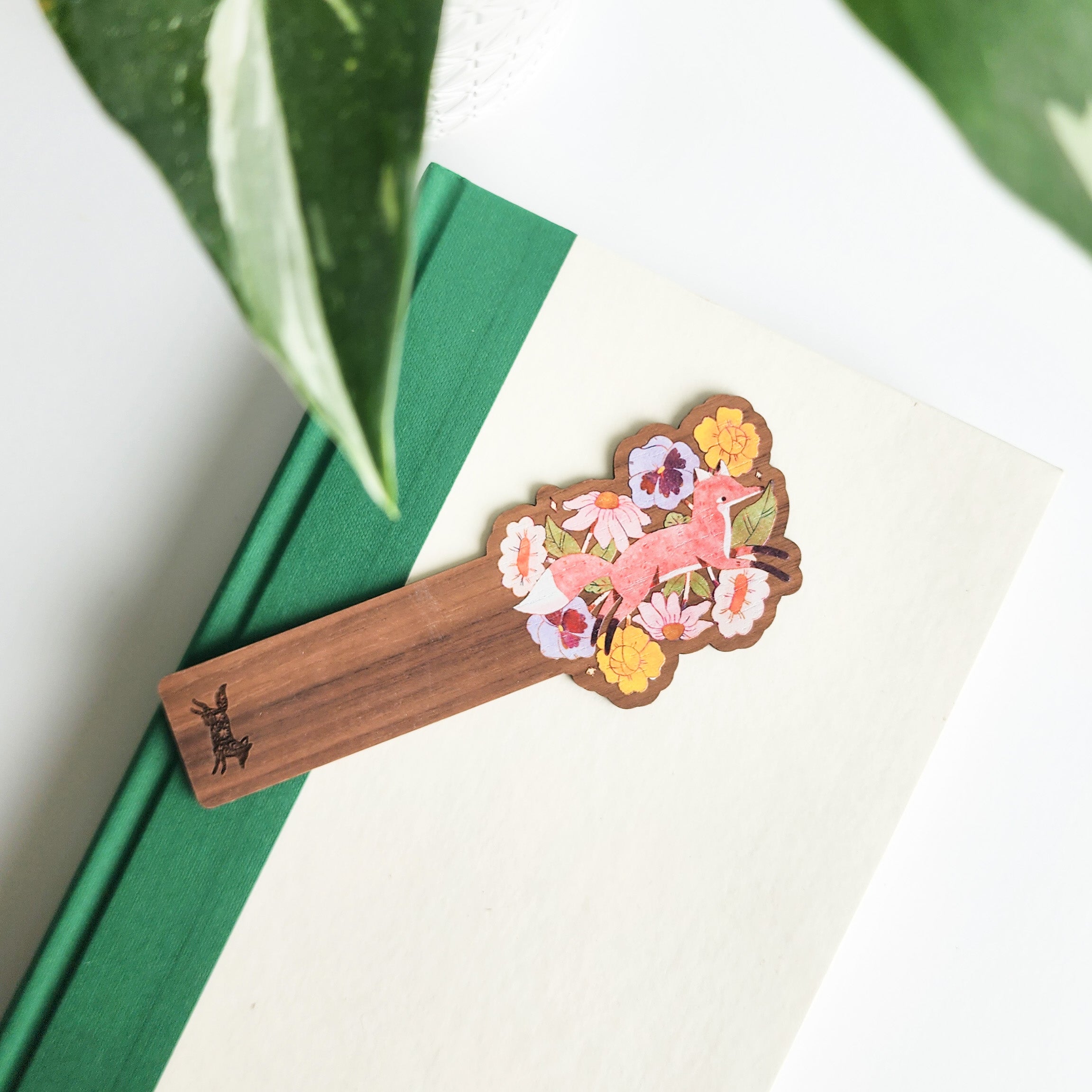 floral fox bookmark on a green and white book on a white background