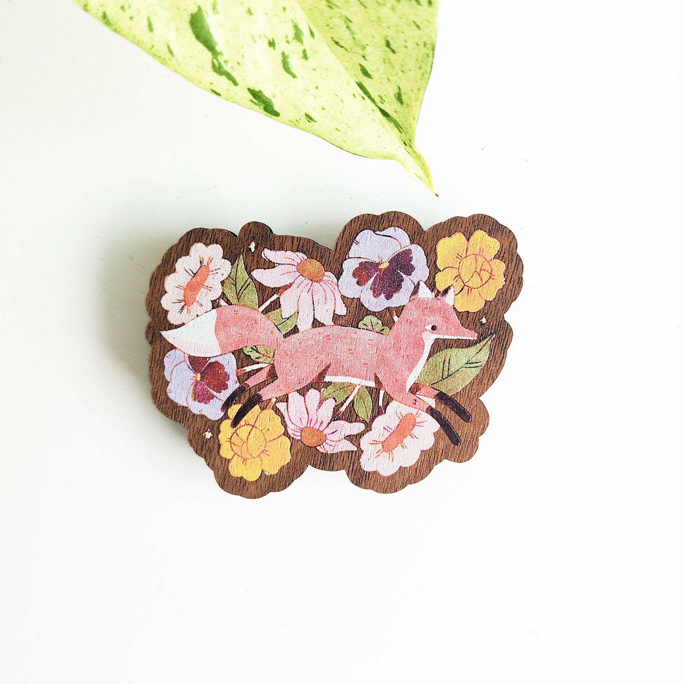 floral fox magnet on a white background with a leaf