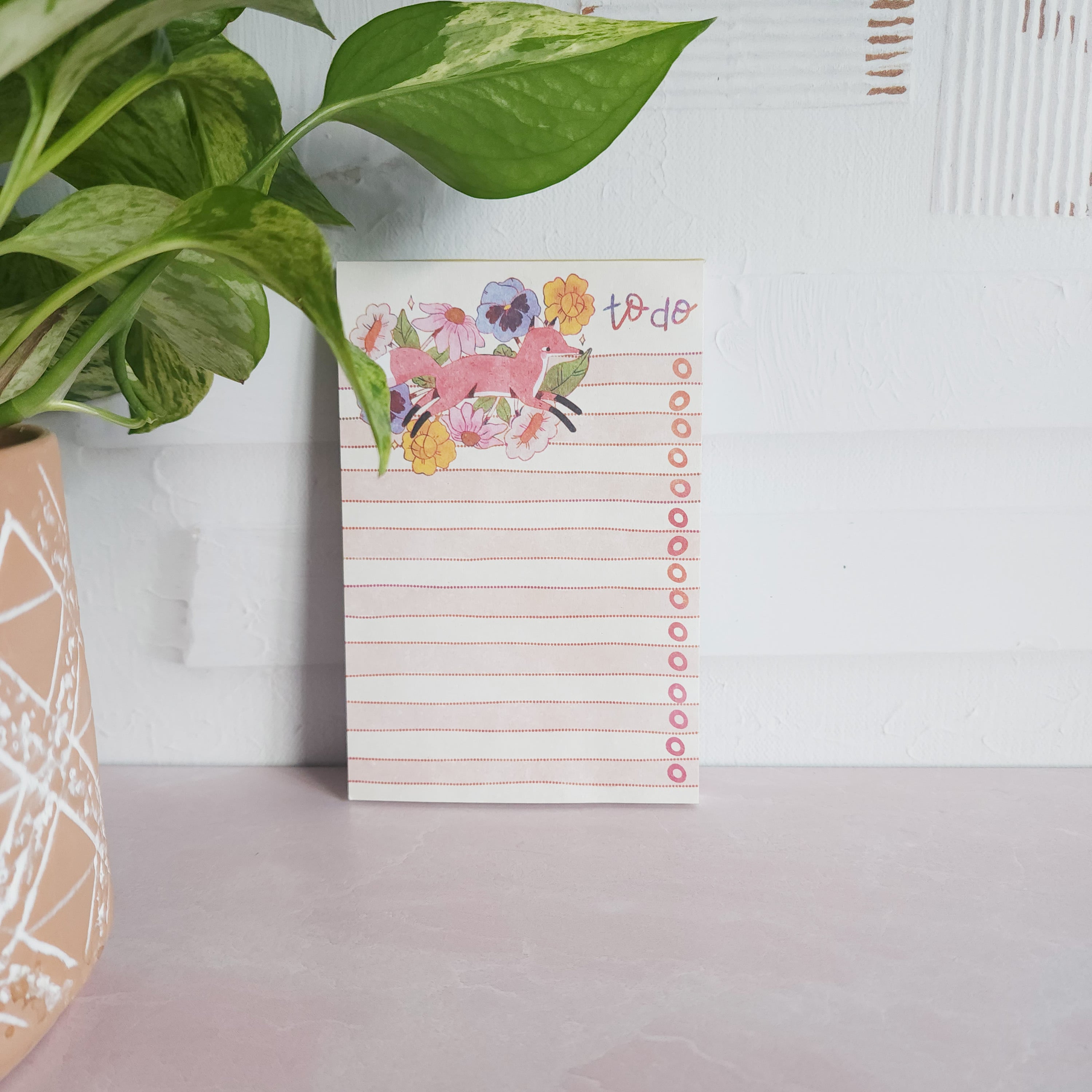 floral fox notepad leaning against a wall