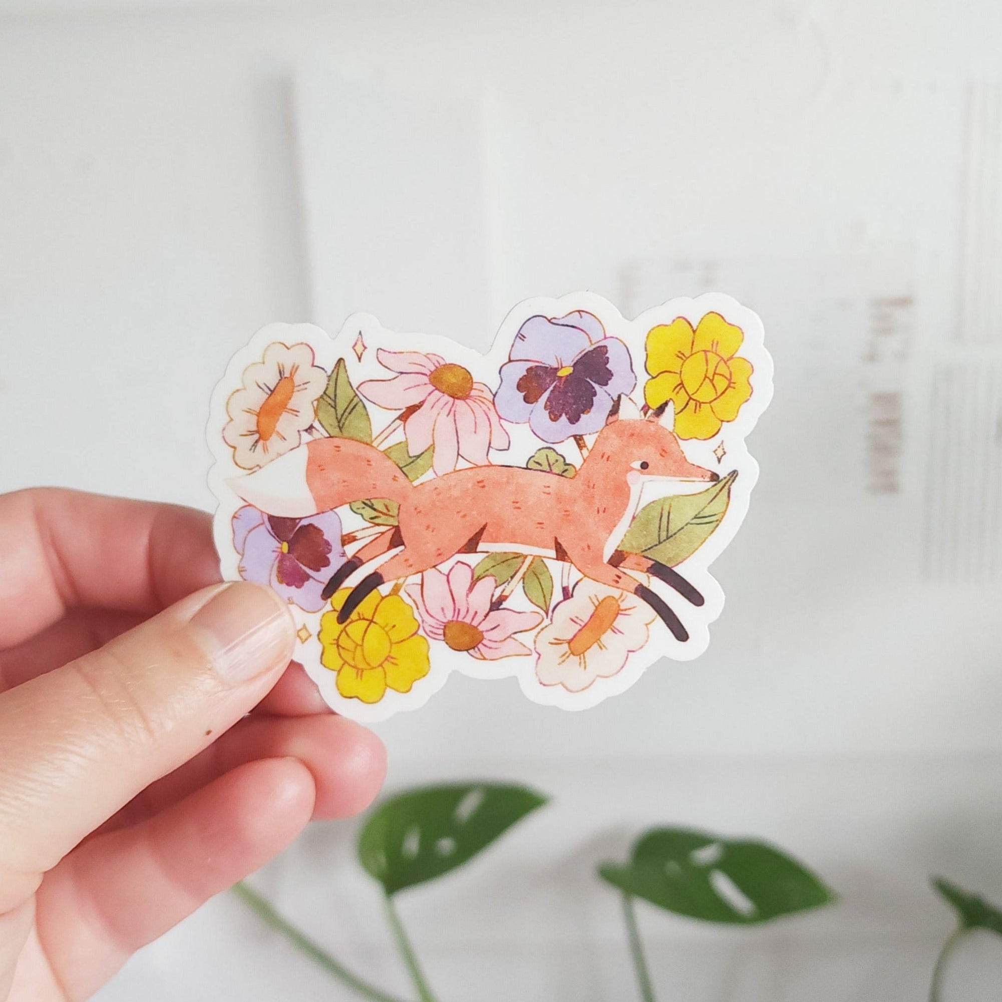 vinyl sticker with a fox jumping through blooming flowers