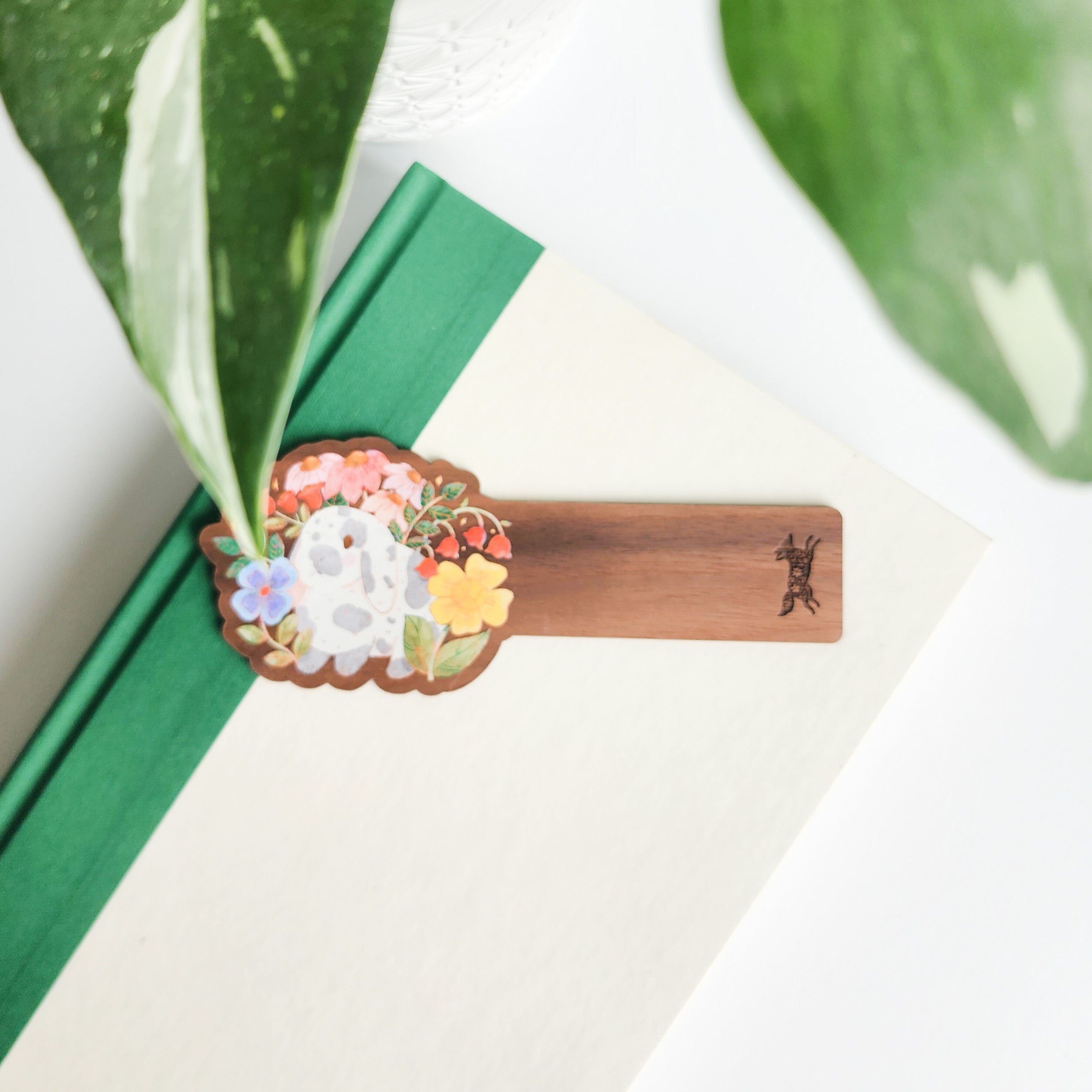floral bunny bookmark sitting on a green and white bookmark on a white background with leaves