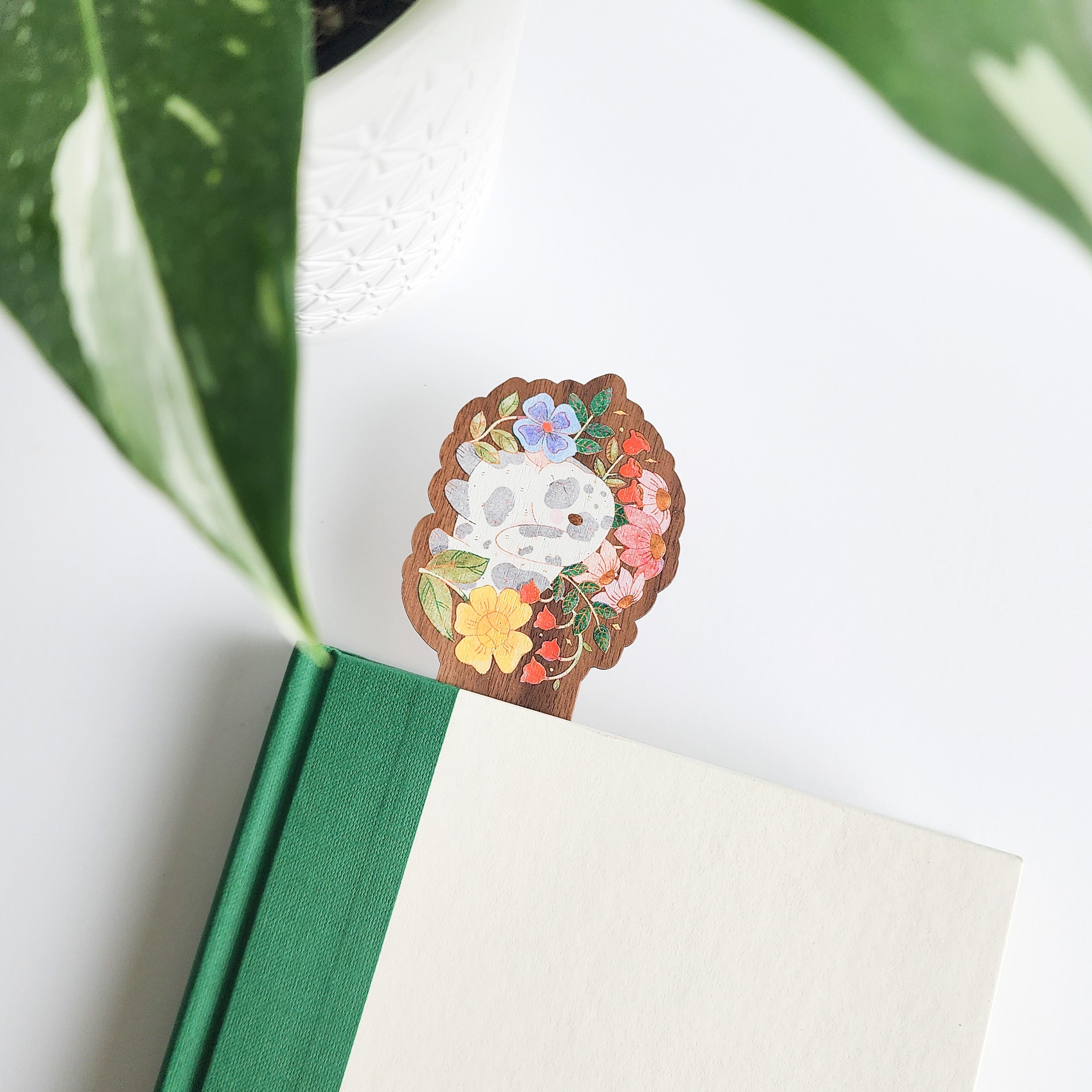 floral bunny bookmark inside of a green and white book on a white background with leaves