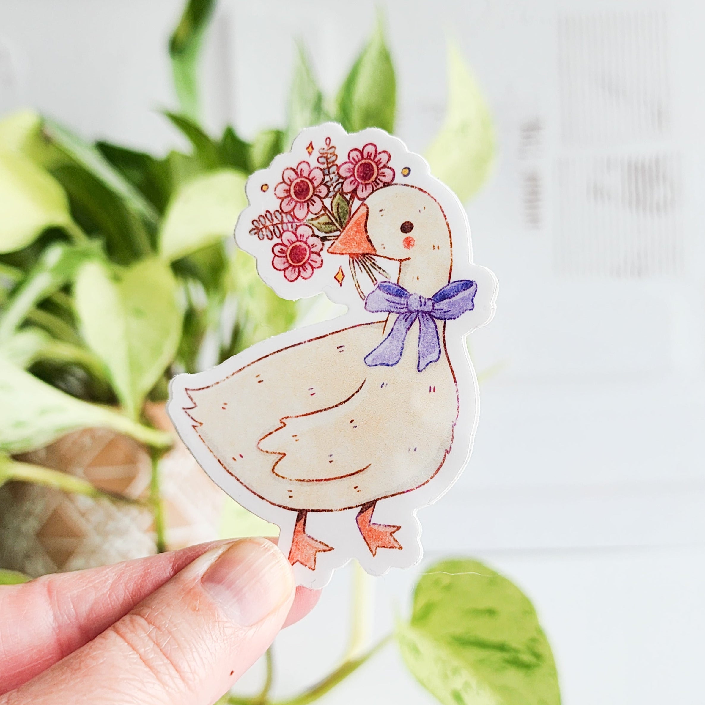 sticker of a goose holding a bouquet of flowers