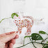 sticker of a cat filled with flowers and the words let yourself bloom