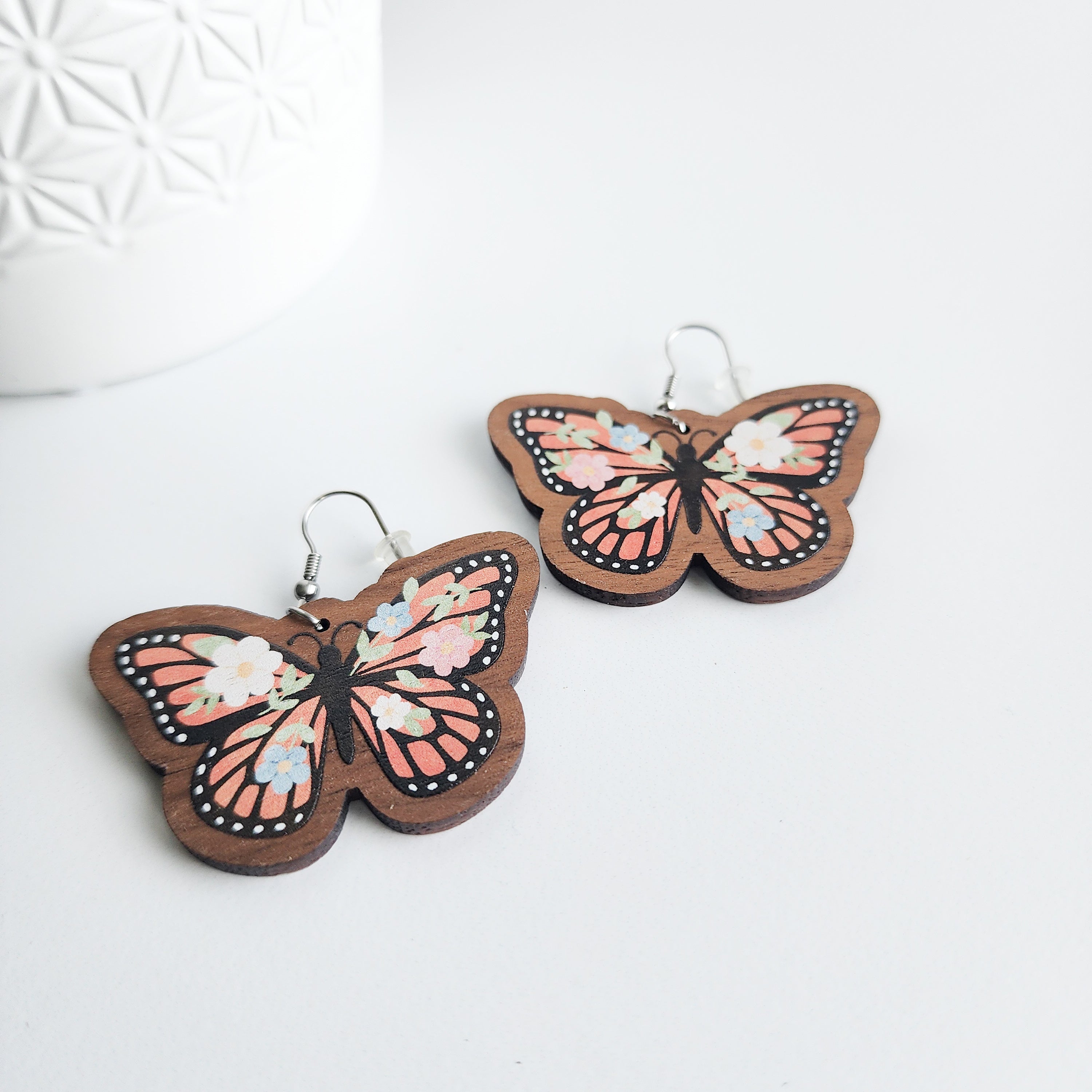 floral butterfly earrings on a white background