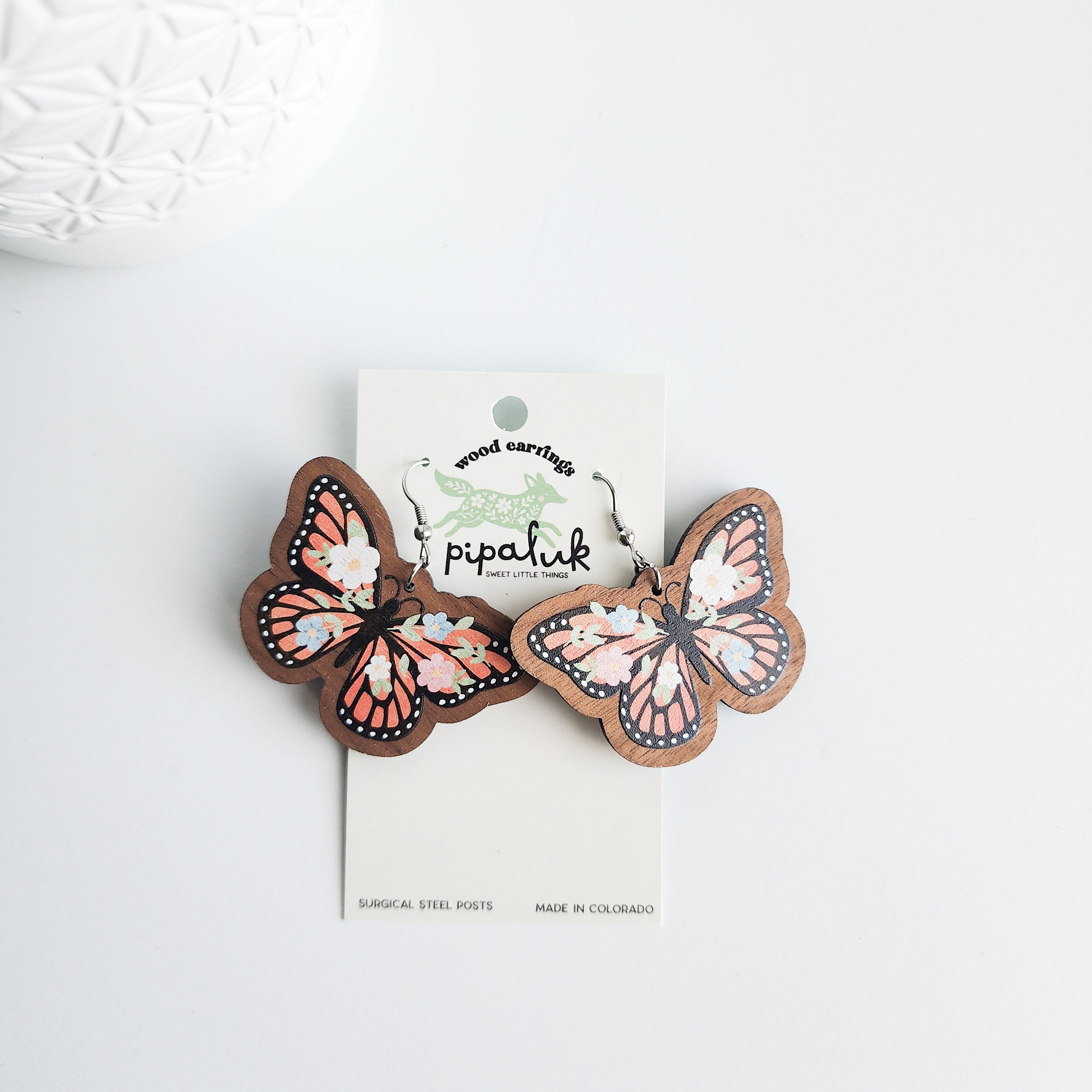 floral butterfly earrings on a Pipaluk earring card on a white background