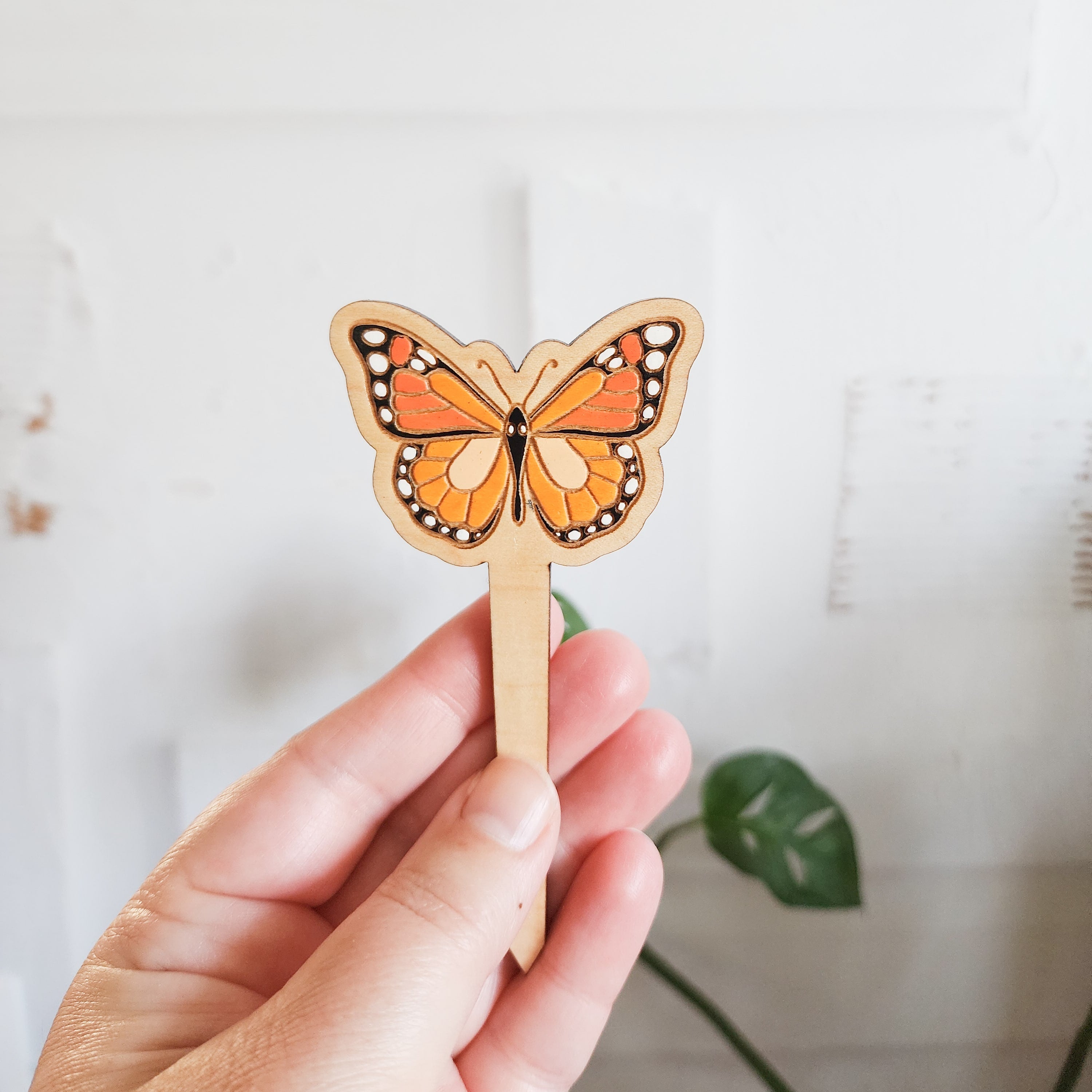 monarch butterfly plant pick held in hand