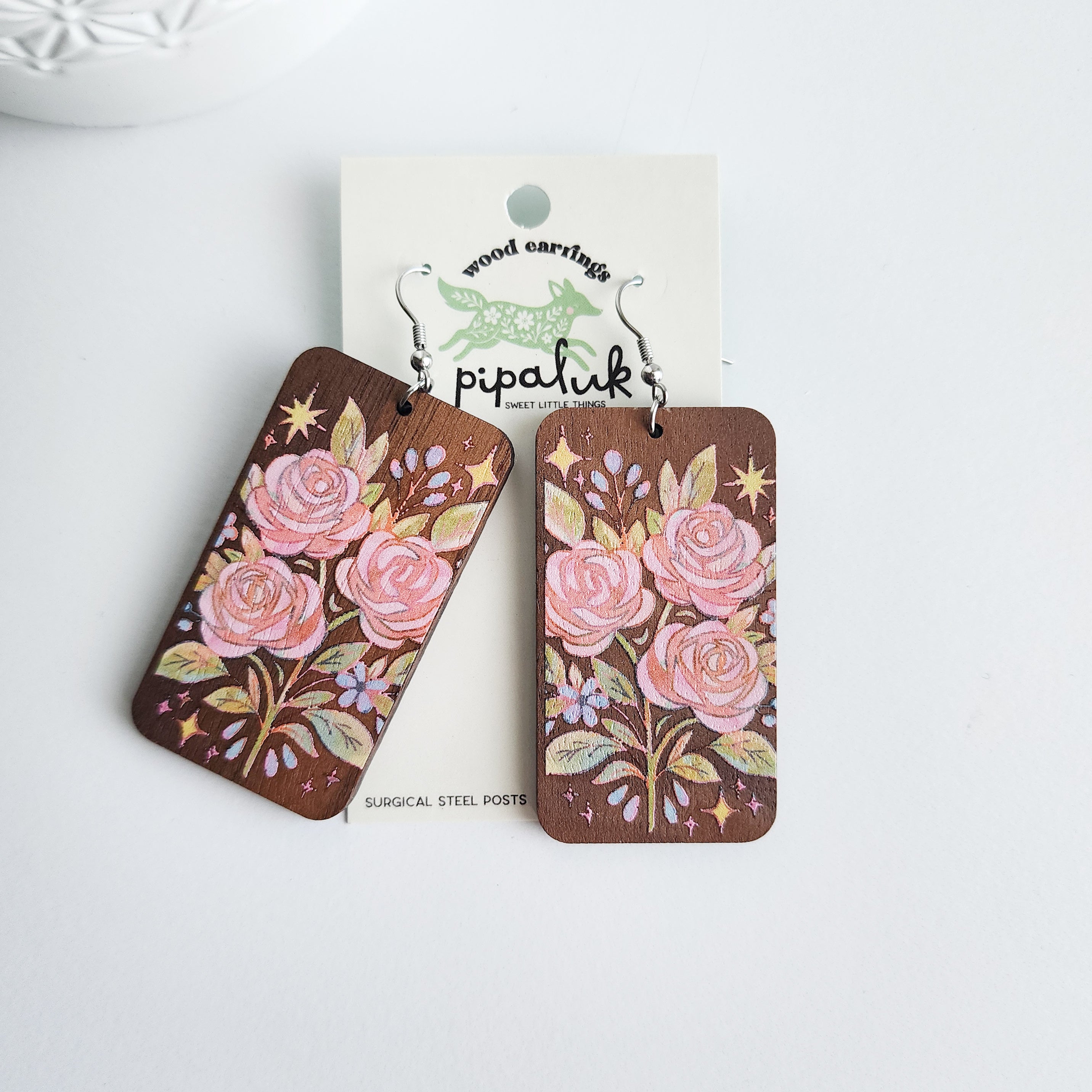 rose bouquet earrings on a Pipaluk branded earring card on a white background