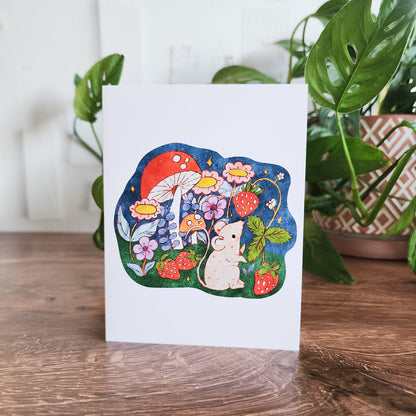 strawberry mouse greeting card in front of a houseplant