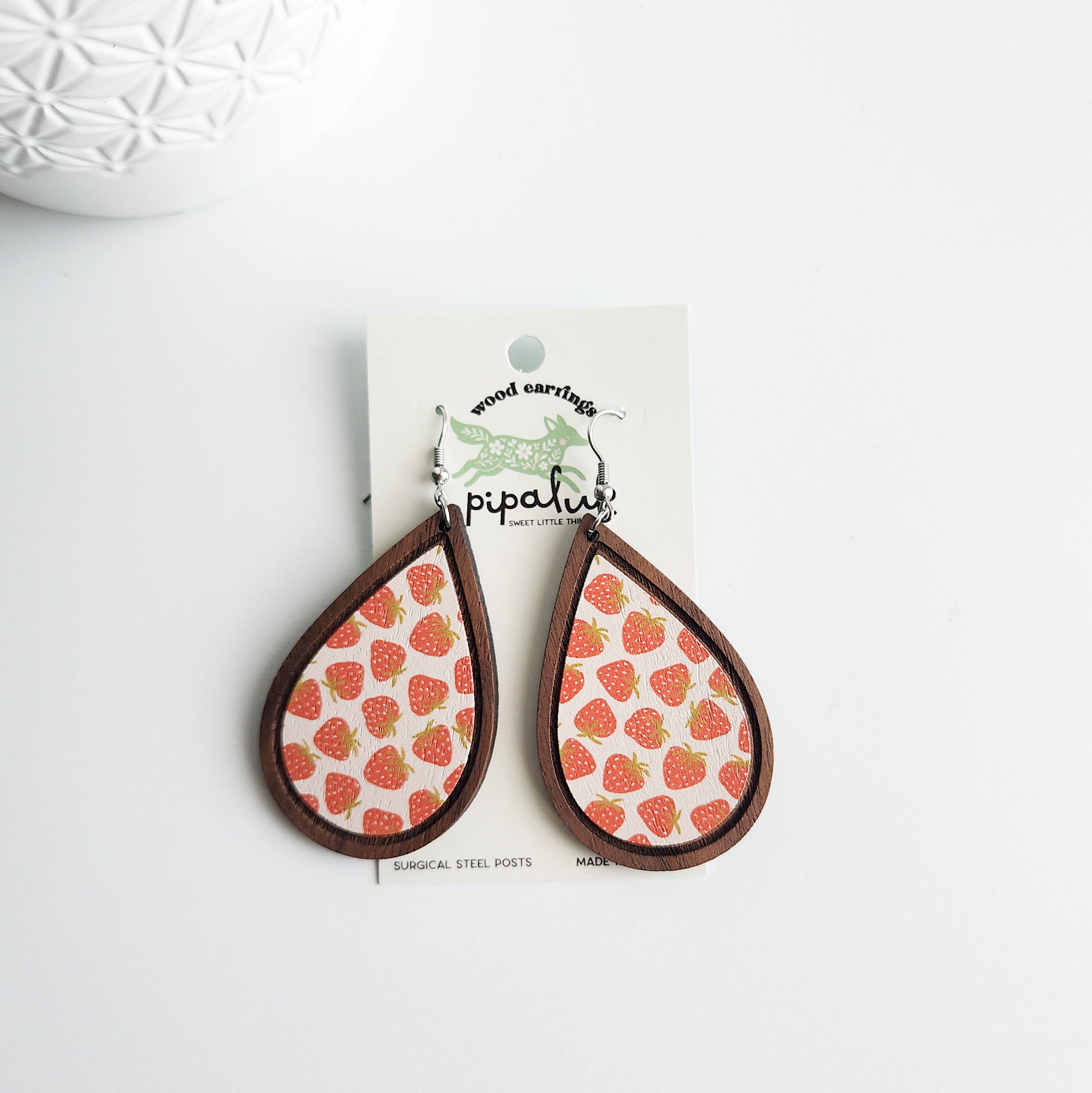 strawberry earrings on a Pipaluk earring card on a white background