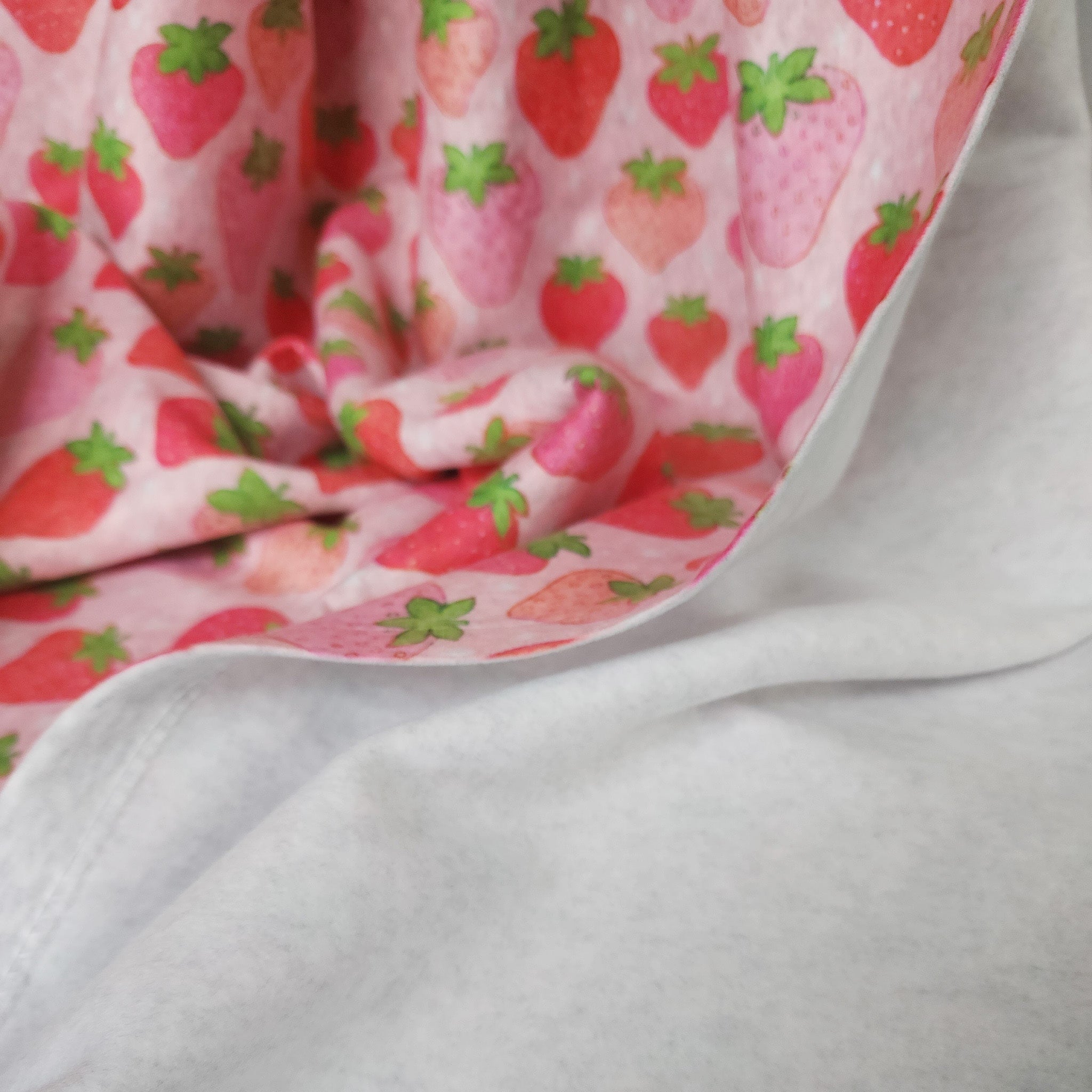 back of strawberry blanket showing a soft gray