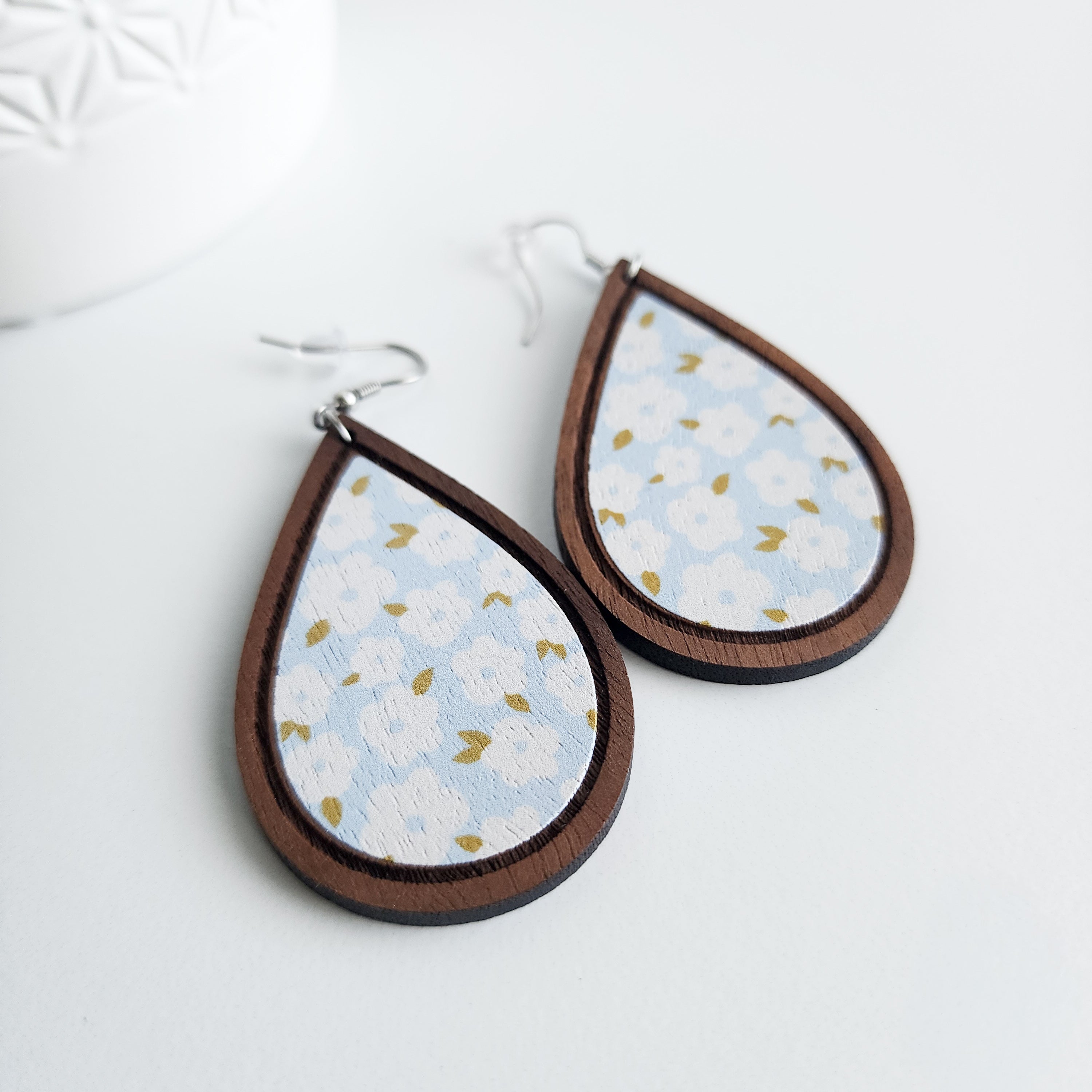wooden blue floral earrings on a white background