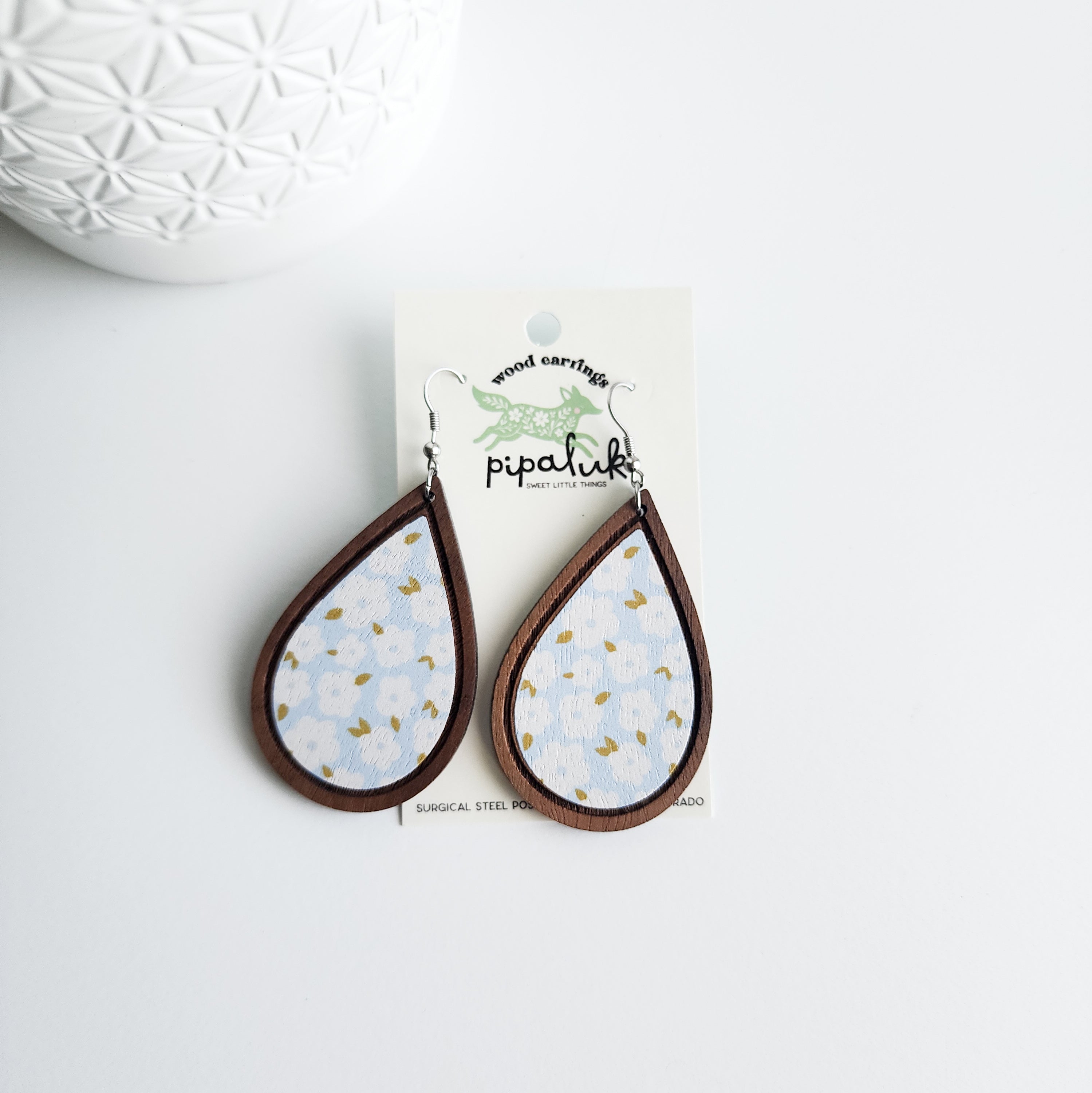 blue floral earrings on a Pipaluk earring card on a white background
