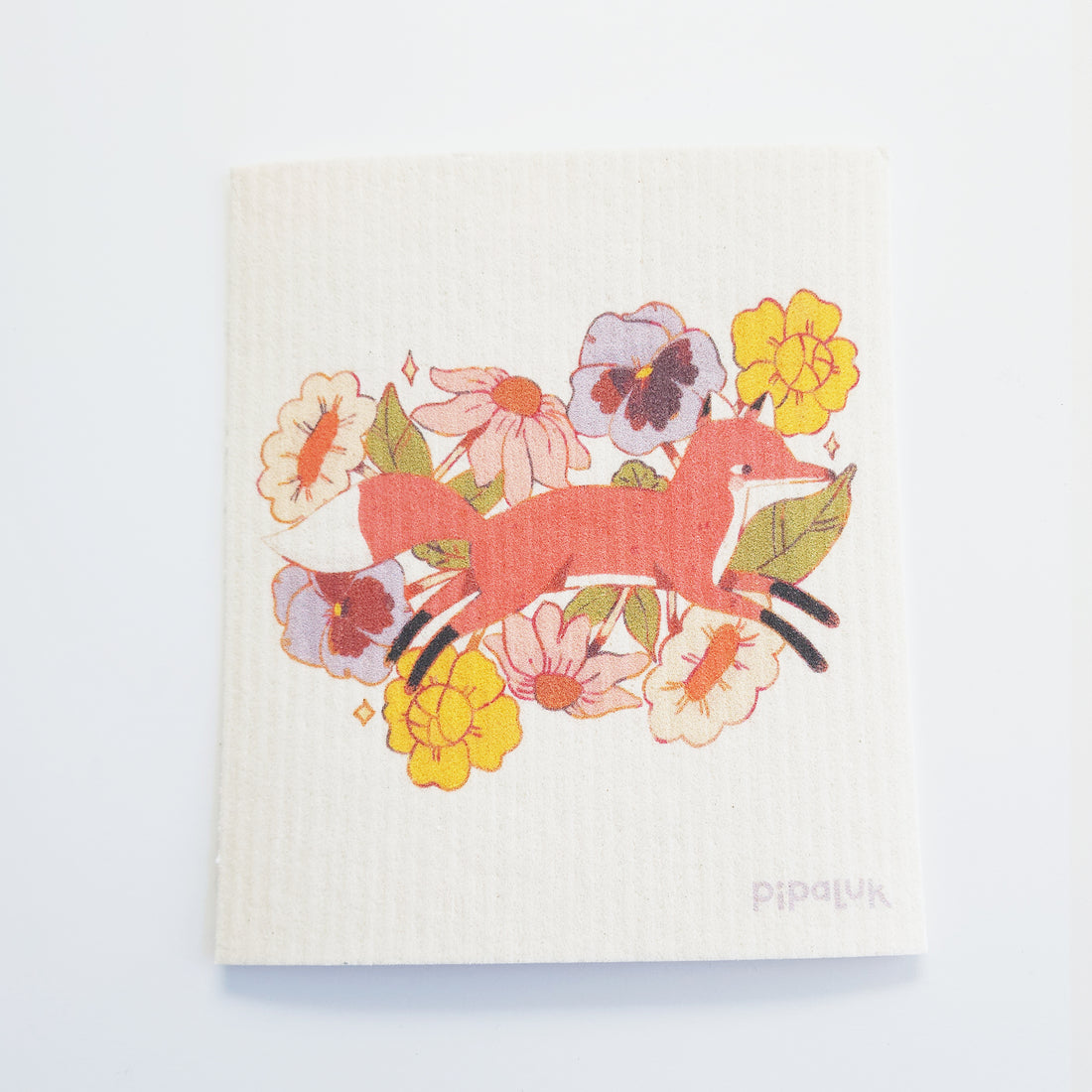 dishcloth with an image of a fox jumping through flowers