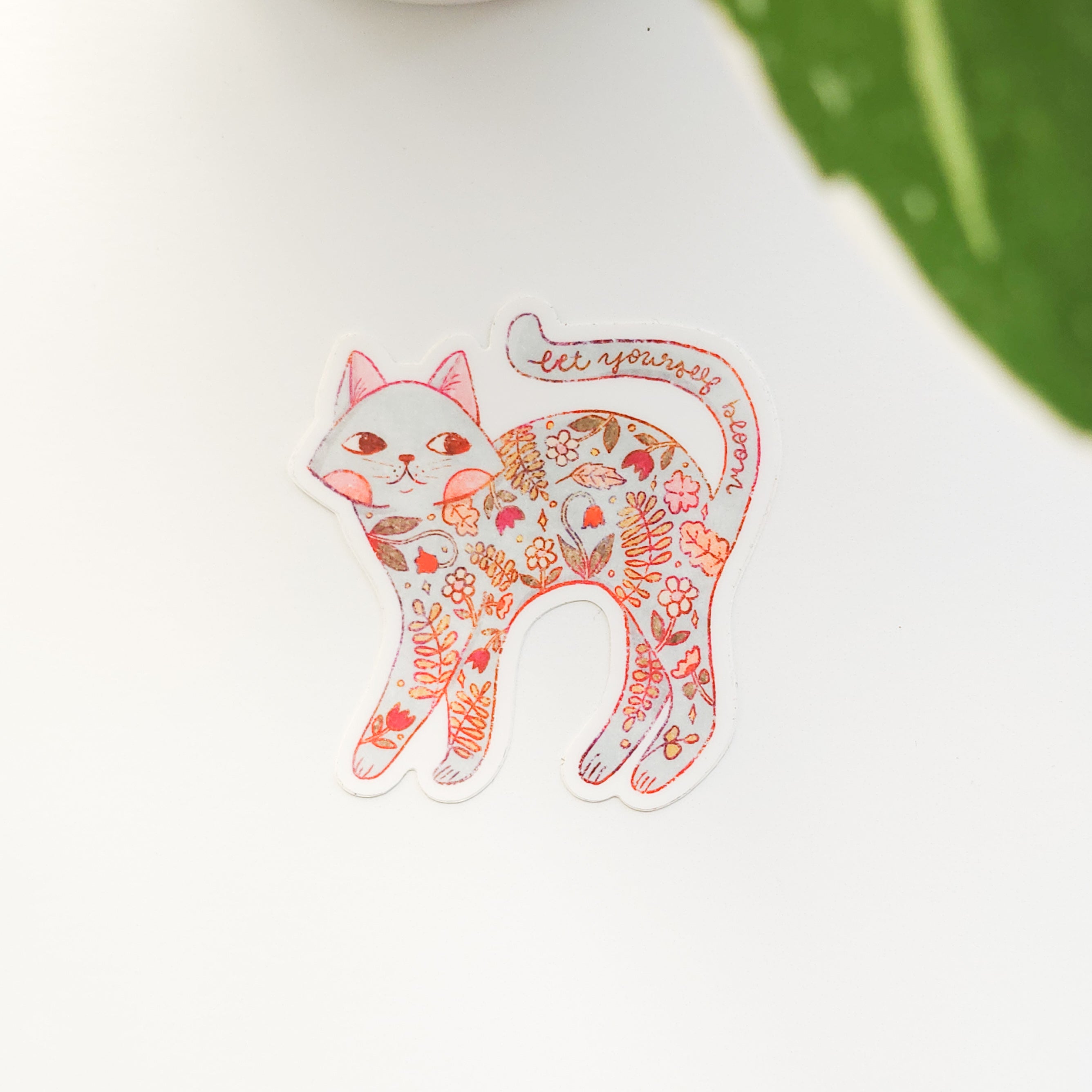 Decorative sticker of a cat with floral patterns on a white background