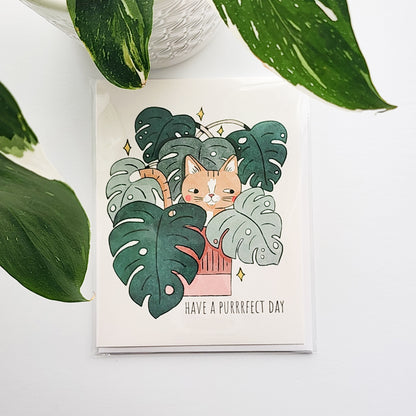 Card with a cat illustration and plant design, text &