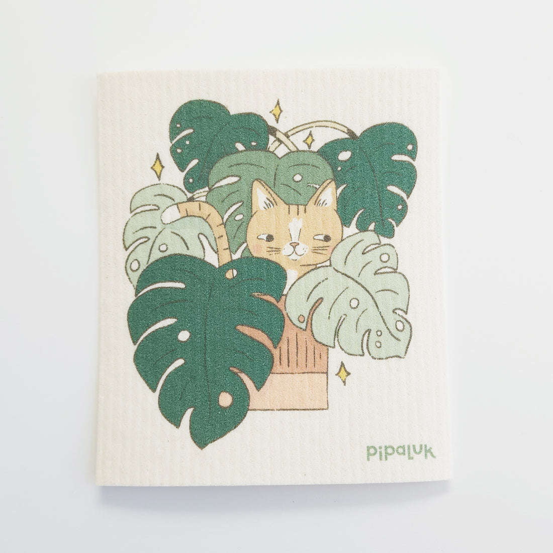 dishcloth with an image of a yellow cat hiding in a monstera plant
