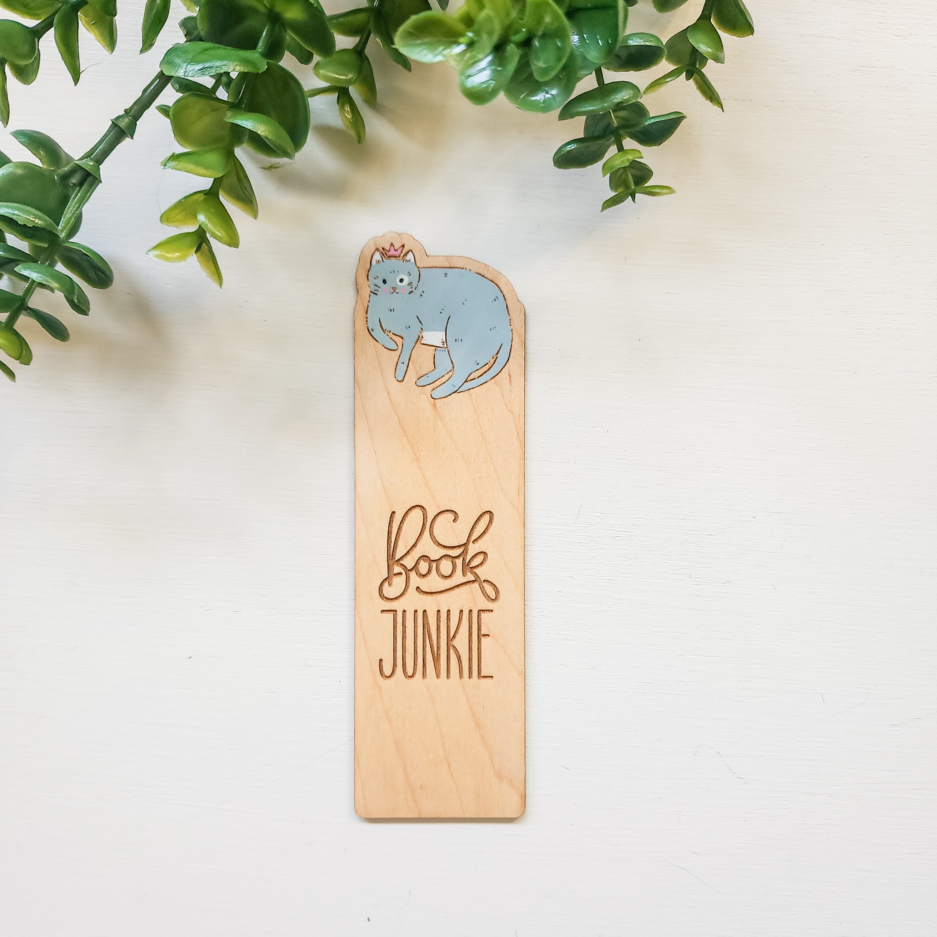 wooden book mark with a blue cat the the words book junkie engraved