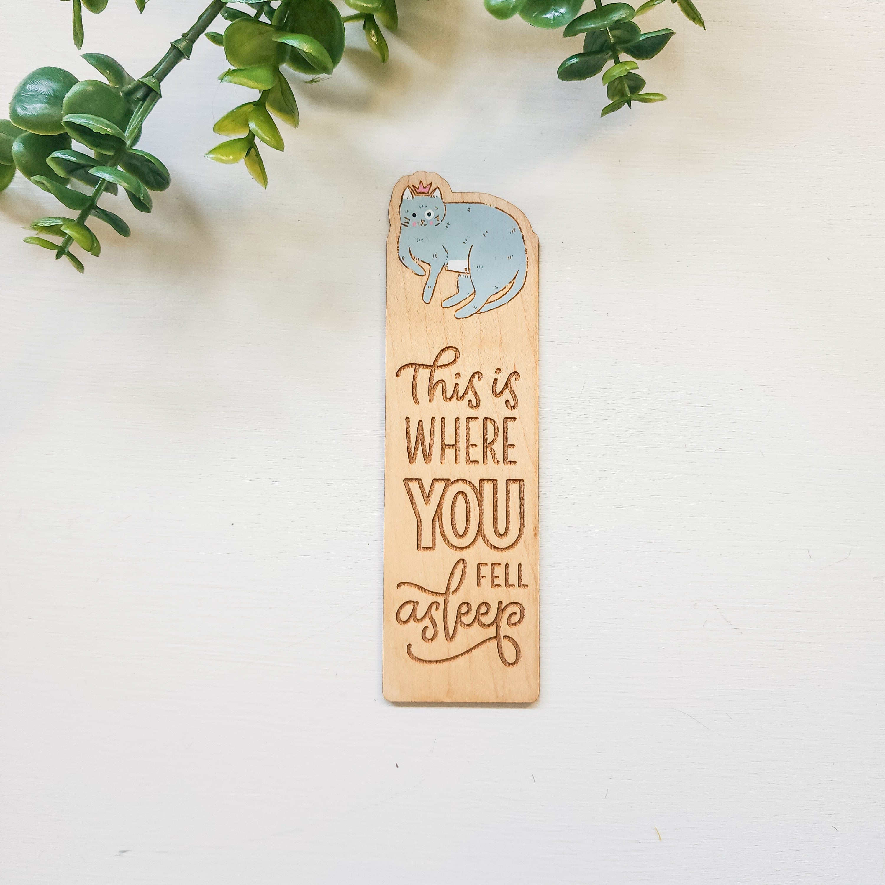 wooden bookmark with a blue cat and the words this is where you fell asleep engraved