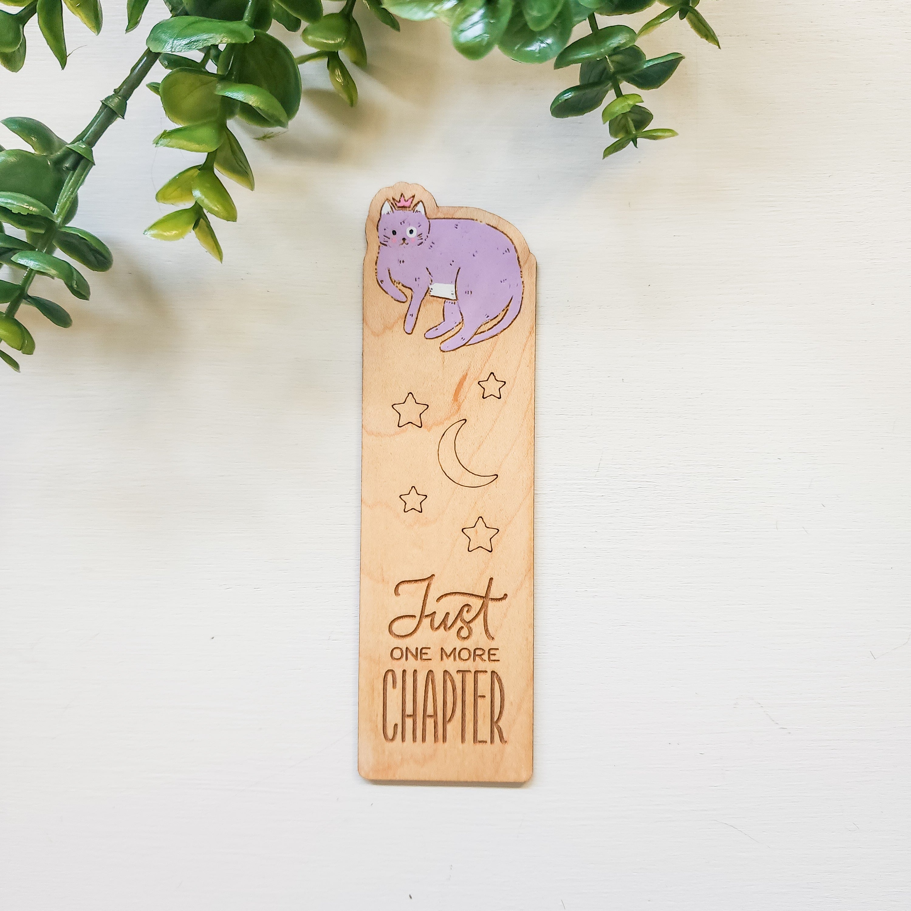 wooden book mark engraved with a cat and the words just one more chapter