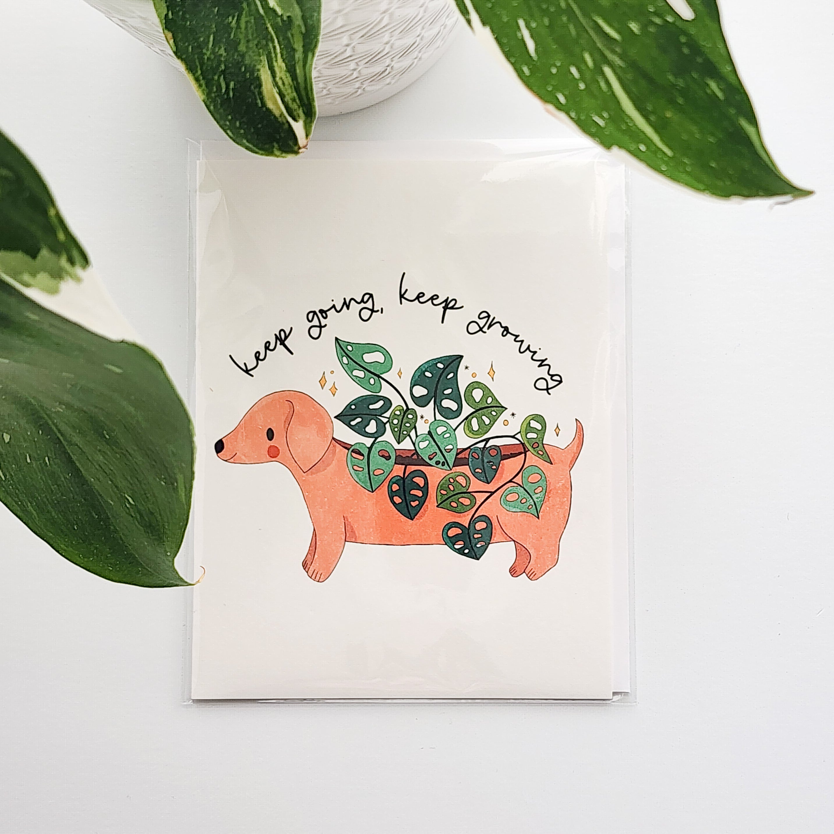 Card with a dachshund plant illustration and &