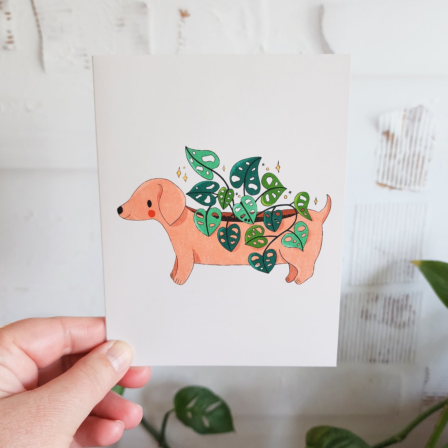 dachshund planter greeting card held by a hand
