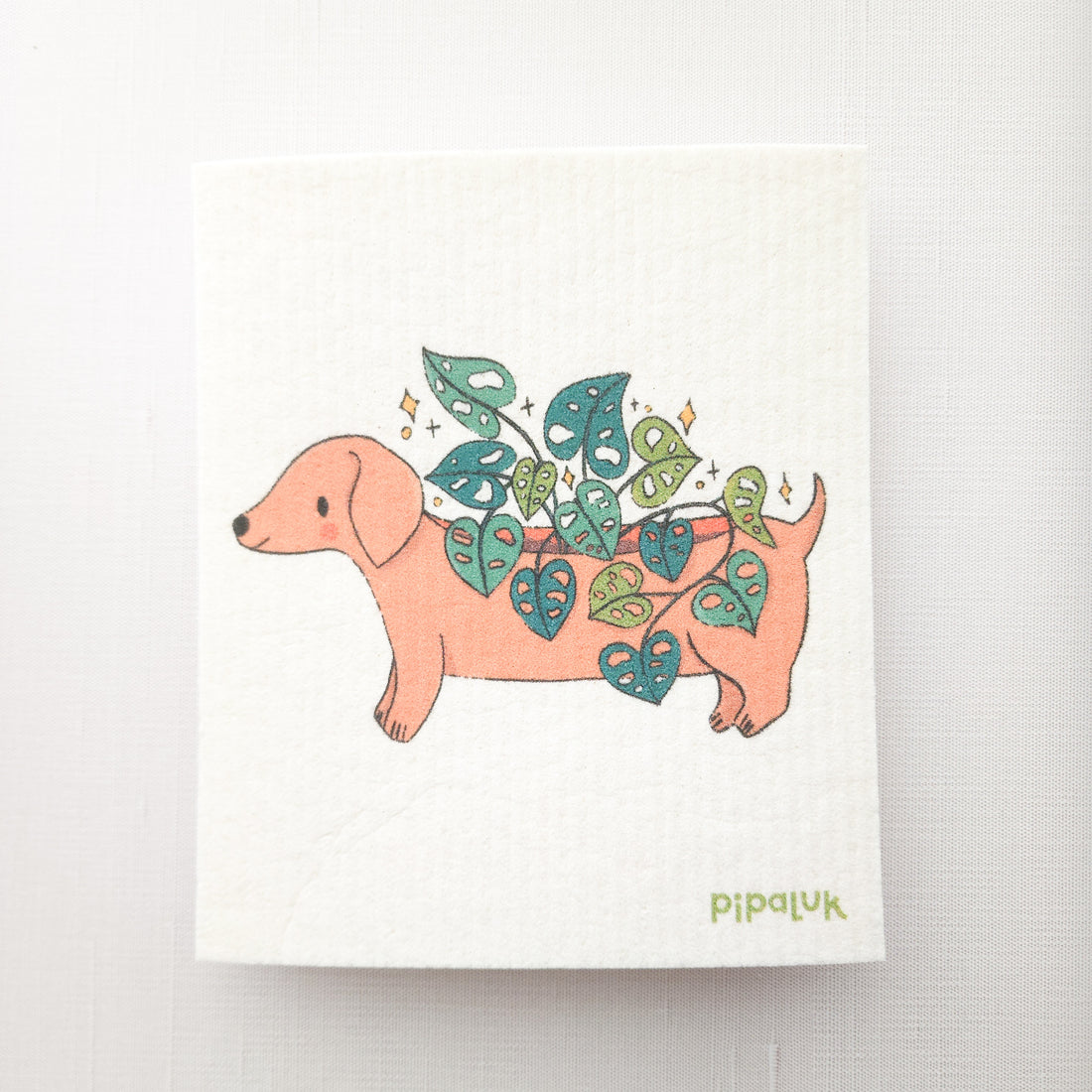 swedish dishcloth with an image of dachshund planter growing a cheese plant, on a white background