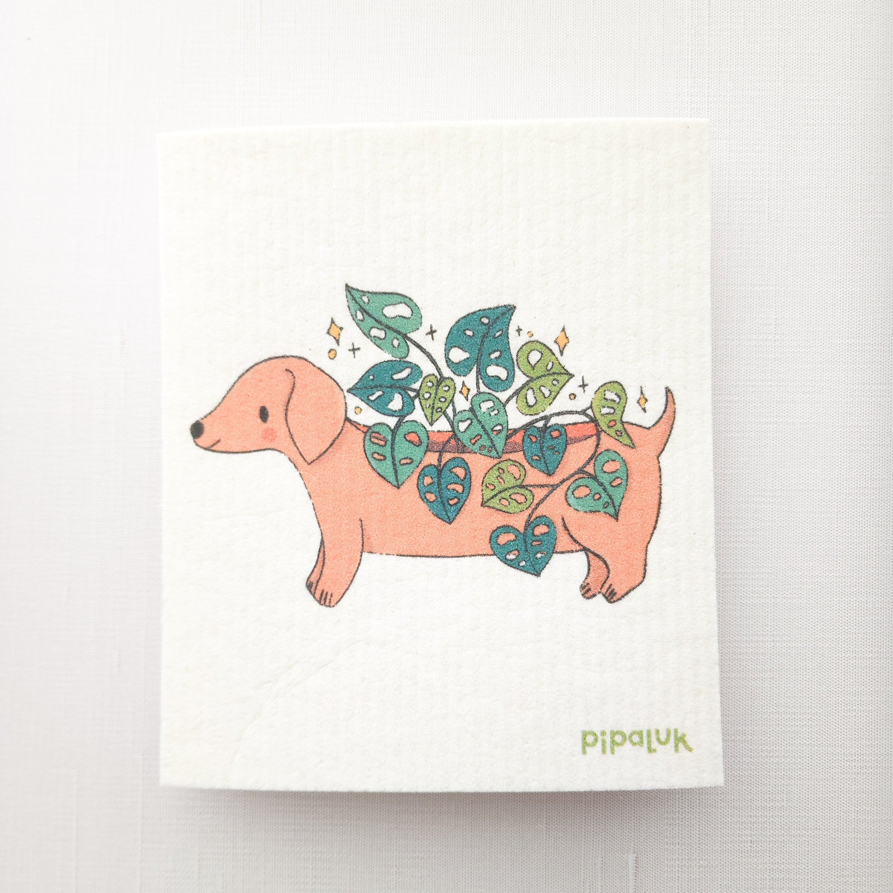 swedish dishcloth with an image of dachshund planter growing a cheese plant, on a white background