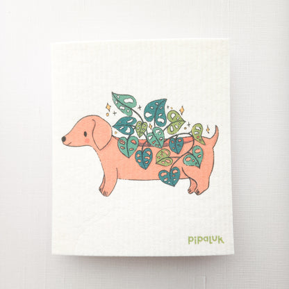 swedish dishcloth with an image of dachshund planter growing a cheese plant, on a white background