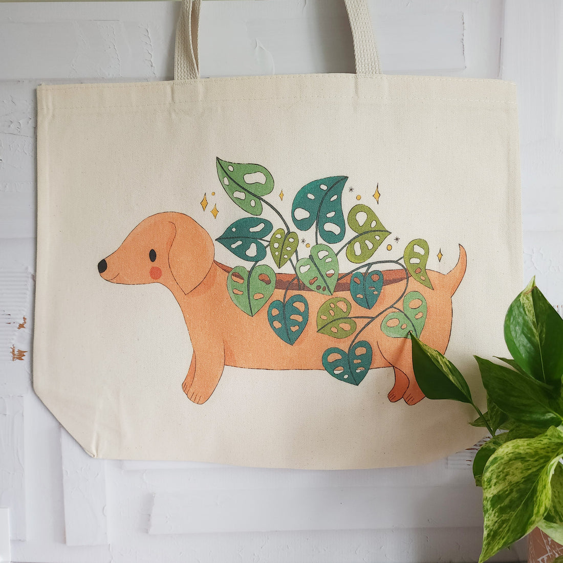 tote bag with a dachshund planter with a cheese plant growing out of its back