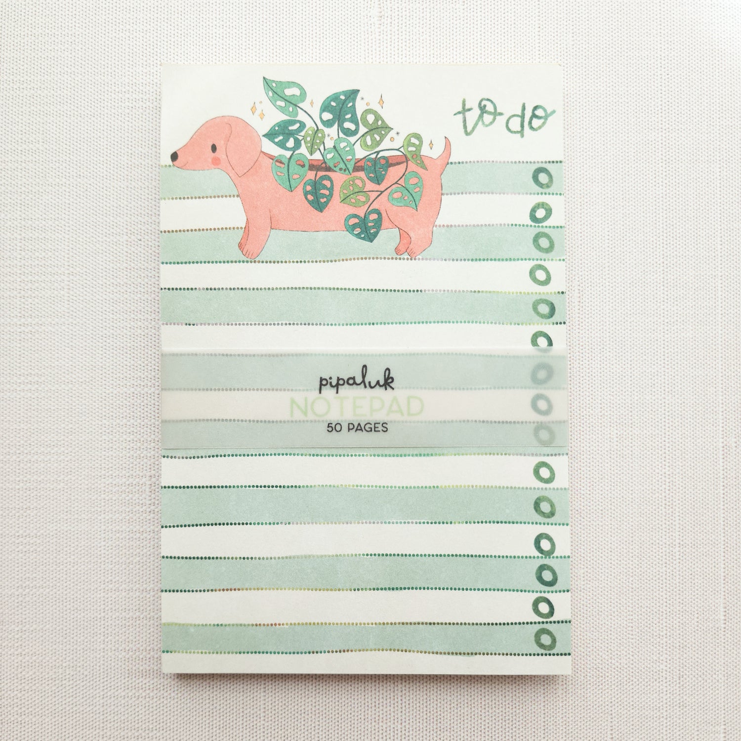 green and white striped notepad with a dachshund illustration and the words to do