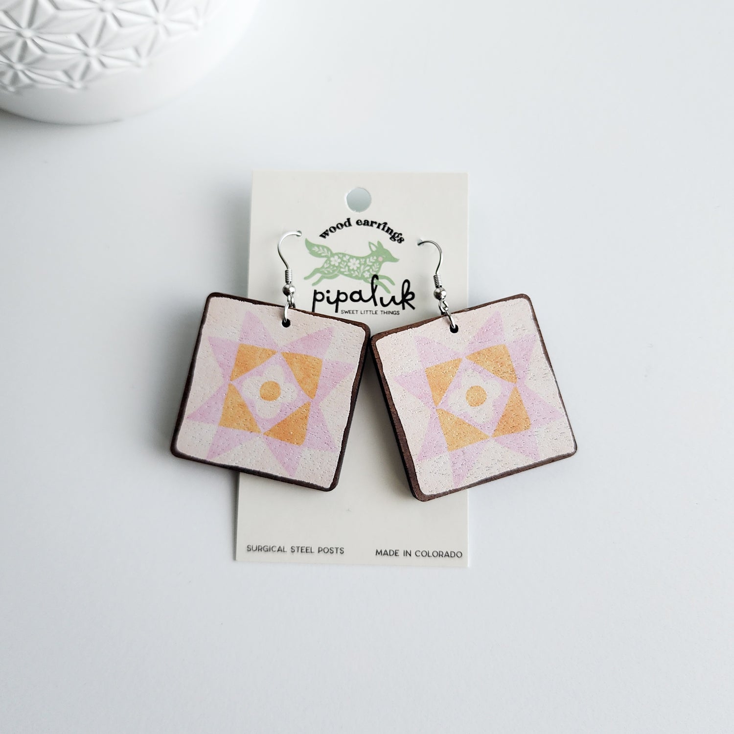 daisy star earrings on a pipaluk earring card on a white background