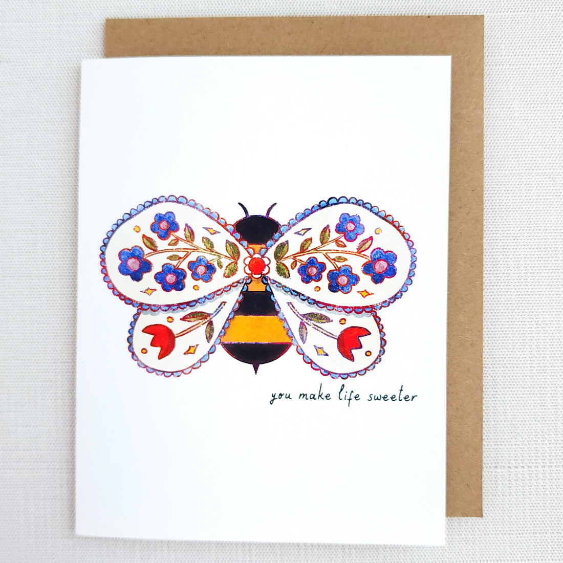 Greeting card with a colorful bee design and floral elements on a white background.