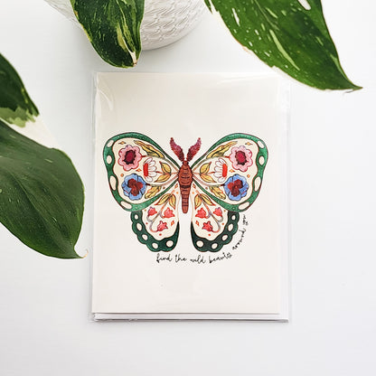 butterfly  card with floral design on a white background with green leaves.