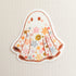 sticker with an illustrated ghost with a floral design on a linen background