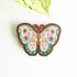 floral butterfly magnet on a white background with a leaf