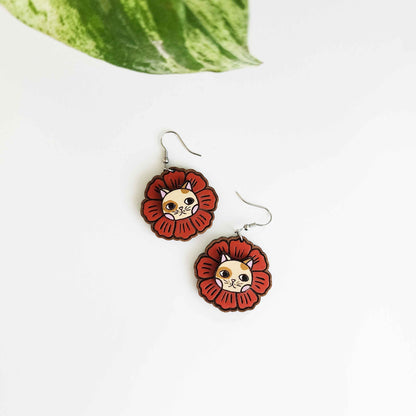 red flower earrings with a cat face in the center