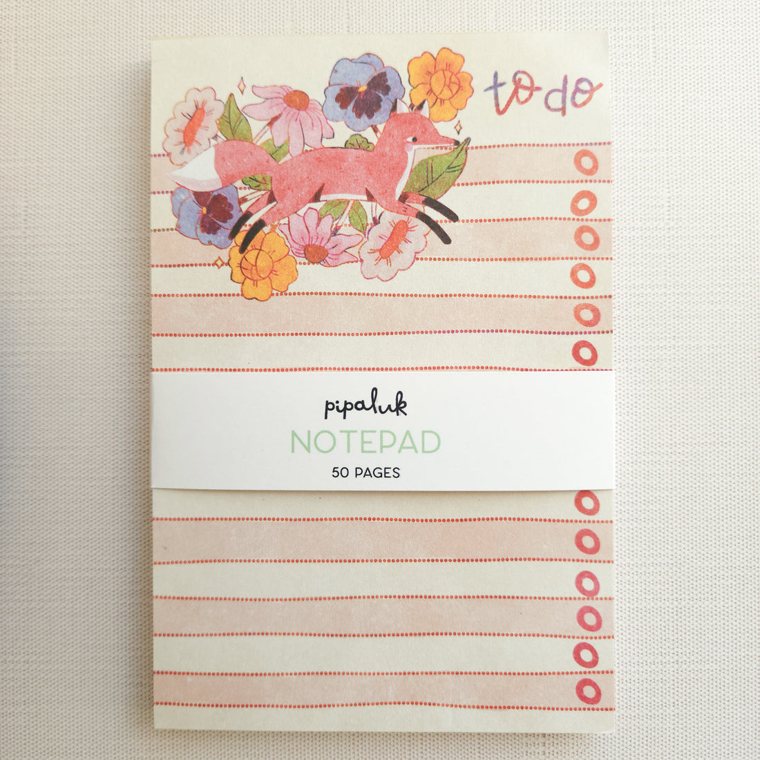 Notepad with fox and floral design on a beige background
