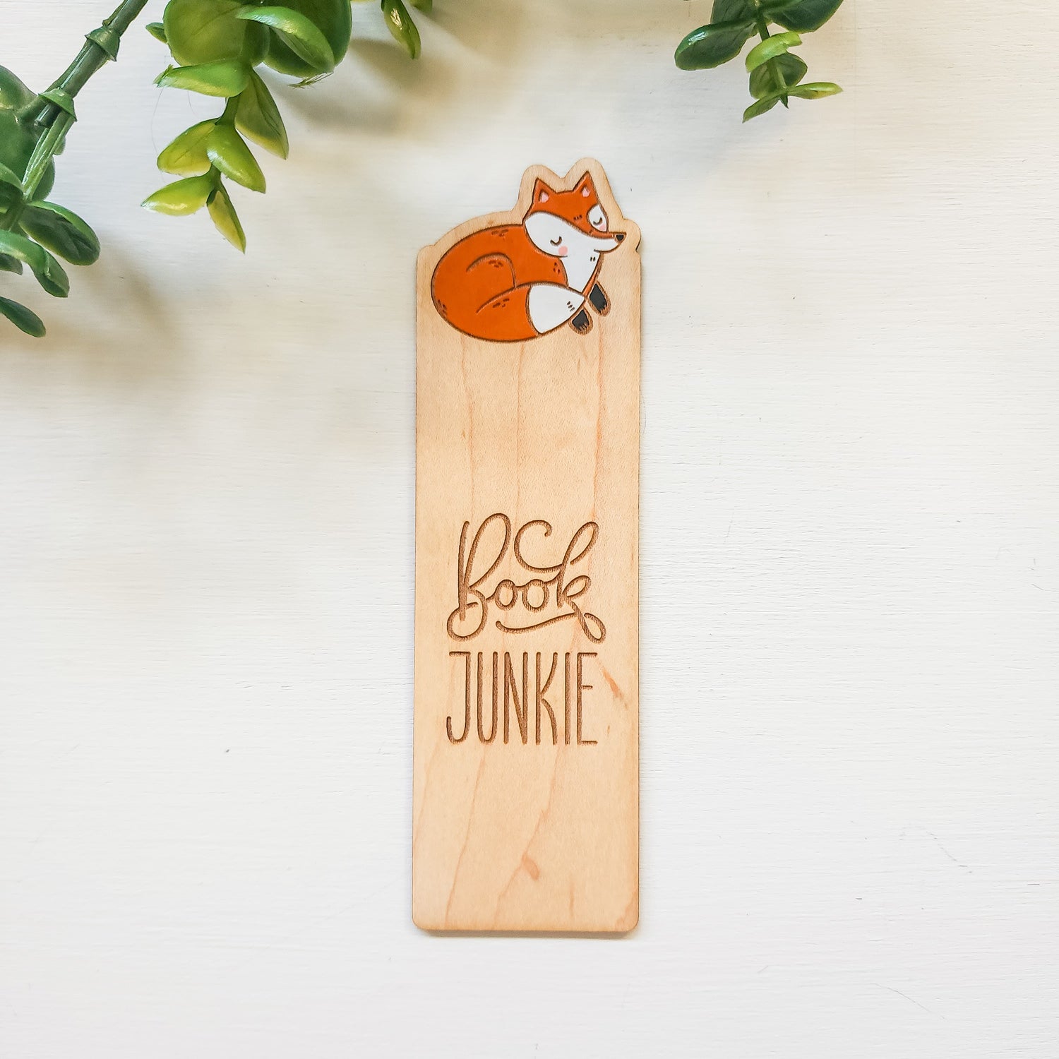 wooden bookmark with a painted fox and book junkie engraved 