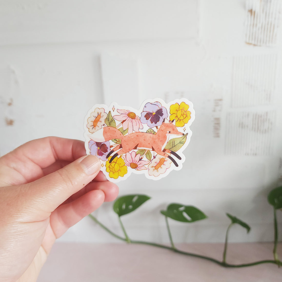 vinyl sticker with a fox jumping through blooming flowers